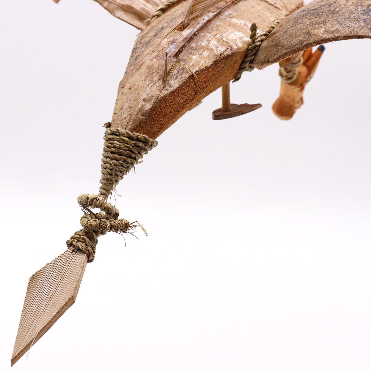Handcrafted Coconut Shell Dragon Mobile - Natural - 37 cm showing a close-up of a bound limb with a pointed wooden foot by Quintessential Holistic Health Ltd