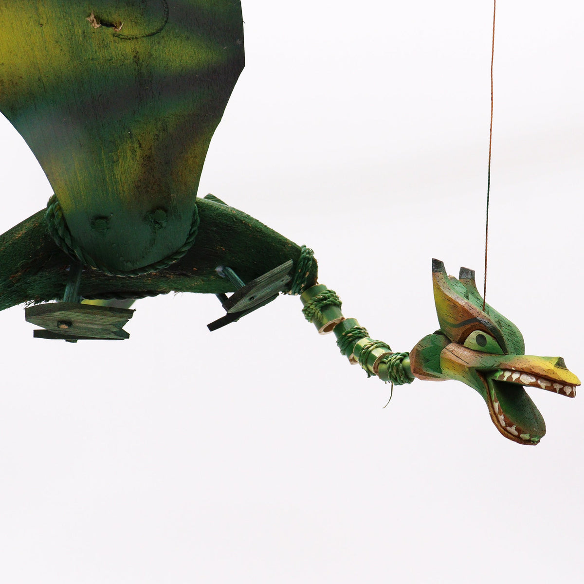 Handcrafted Green Coconut Shell Dragon Mobile - 37cm shown close up with a raised wing, jointed neck and colourful head by Quintessential Holistic Health Ltd