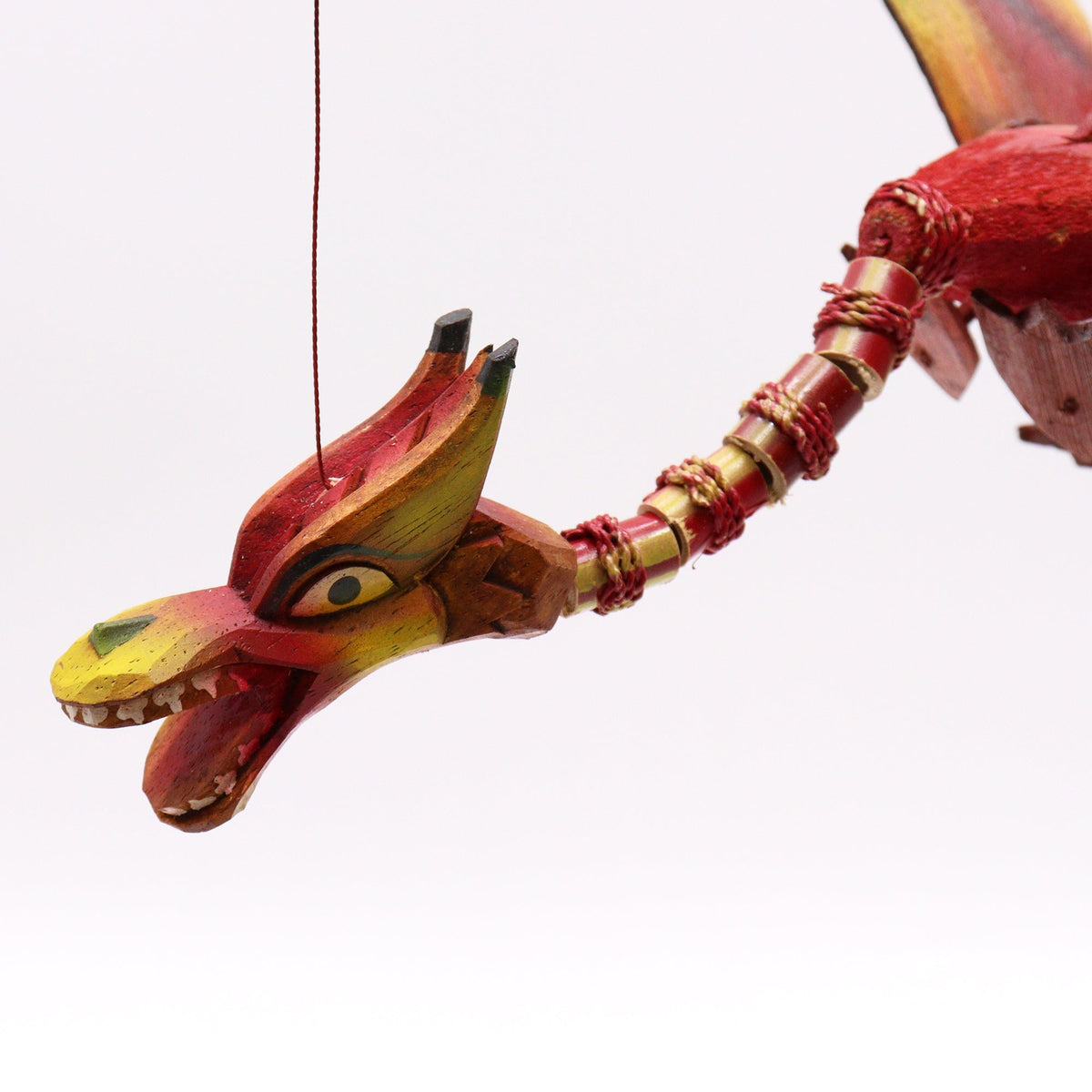 Handcrafted Coconut Shell Dragon Mobile - Red, close-up of the red and yellow head with a long jointed neck by Quintessential Holistic Health Ltd