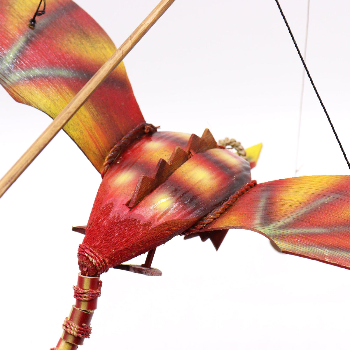 Handcrafted Coconut Shell Dragon Mobile - Red, close-up of the red body, striped wings and crossed wooden supports by Quintessential Holistic Health Ltd