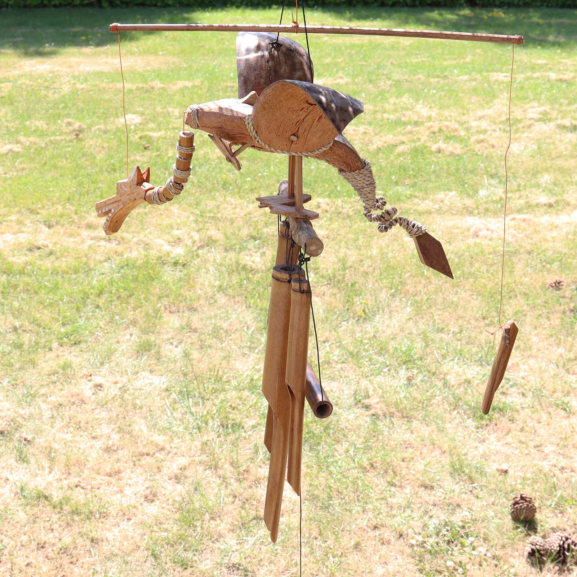 Handcrafted Coconut Shell Wind Chime - Dragon, complete hanging dragon and chime arrangement outdoors by Quintessential Holistic Health Ltd