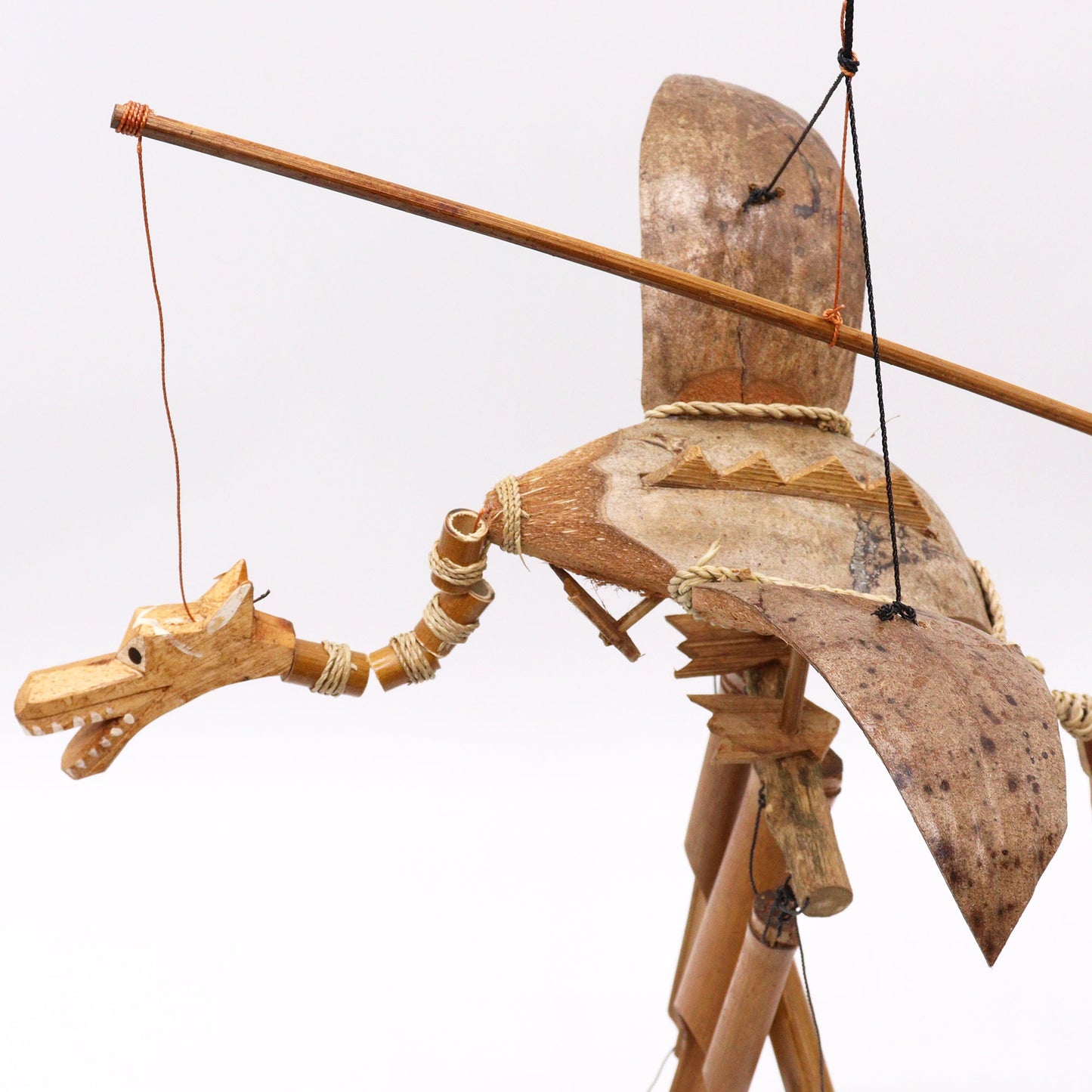Handcrafted Coconut Shell Wind Chime - Dragon, winged dragon with a long segmented neck and horizontal hanging bar by Quintessential Holistic Health Ltd