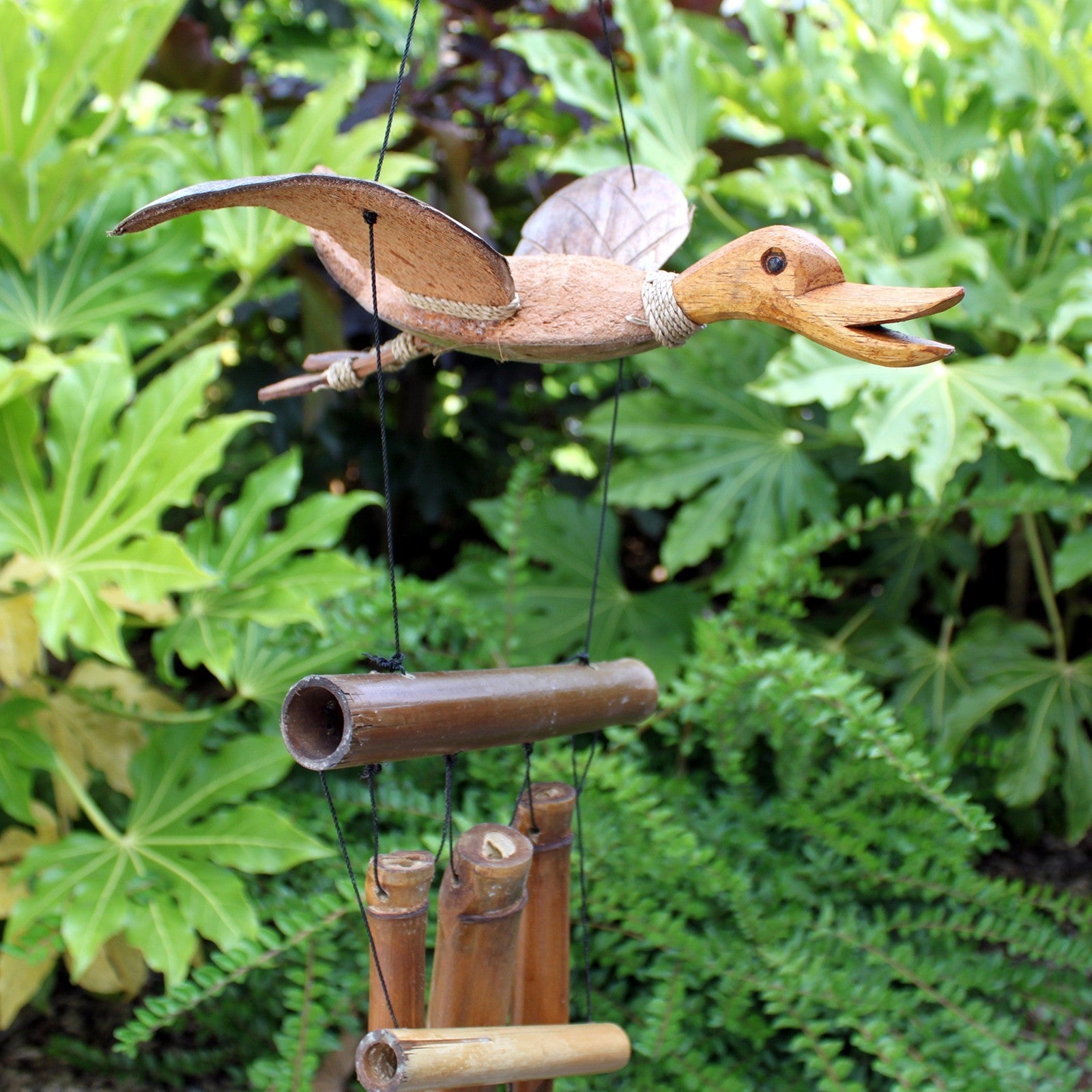 Handcrafted Coconut Shell and Bamboo Wind Chime - Duck, carved duck with an open beak above suspended bamboo tubes by Quintessential Holistic Health Ltd