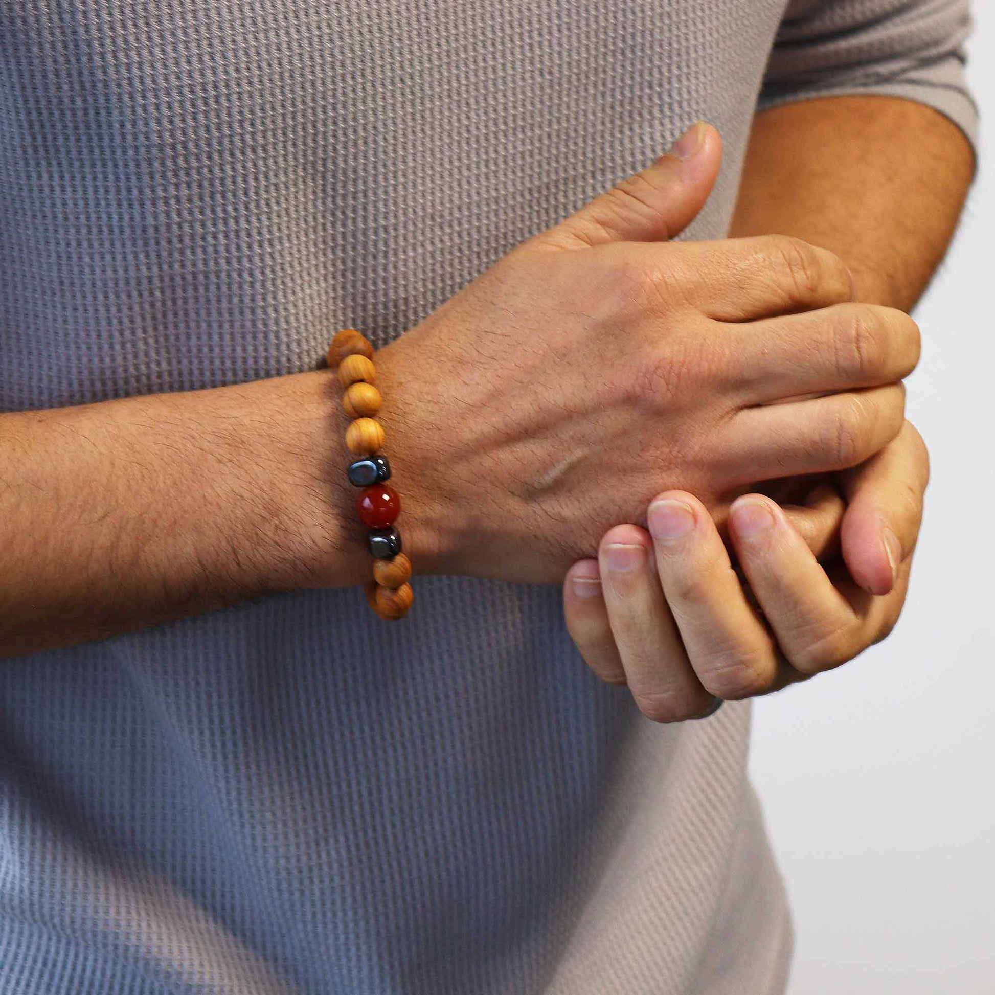 Unisex Cedarwood Root Chakra Bracelet with Red Jasper product packaging on clean background from Quintessential Holistic Health Ltd