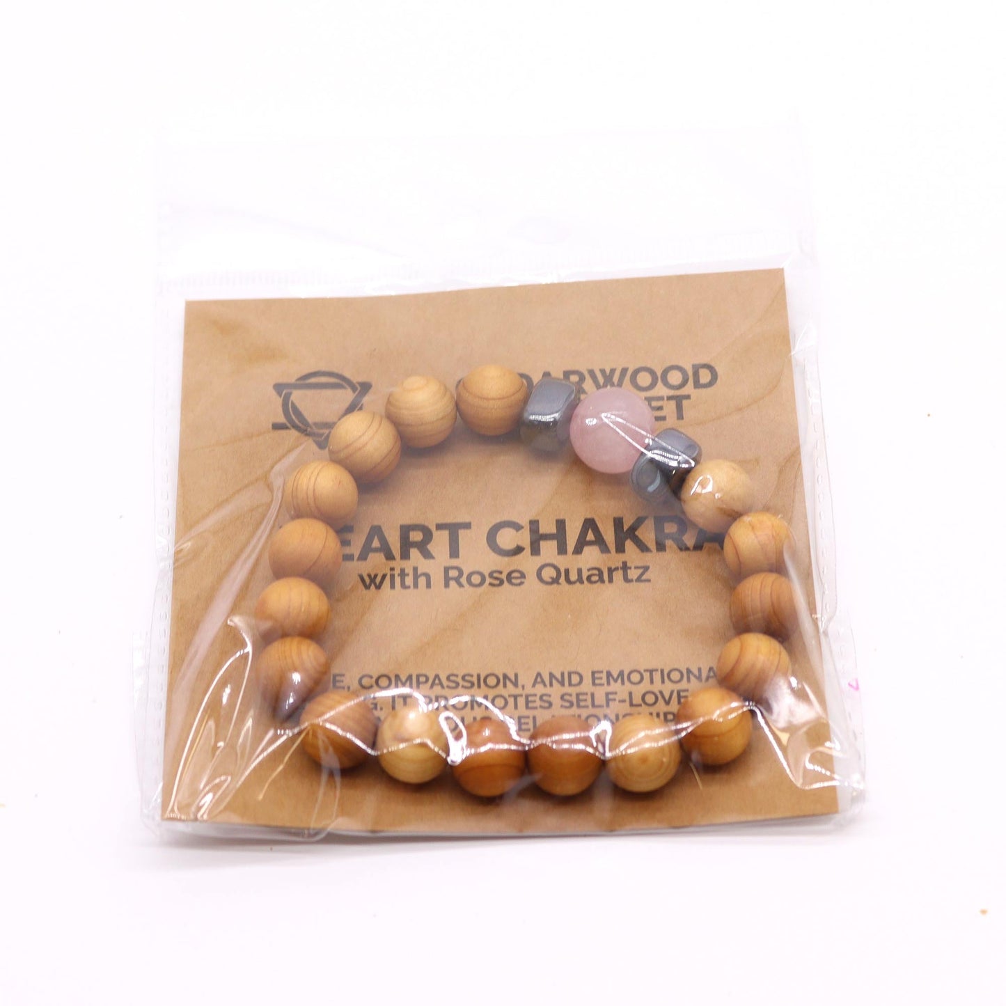 Unisex Cedarwood Heart Chakra Bracelet with Rose Quartz product packaging on clean background from Quintessential Holistic Health Ltd
