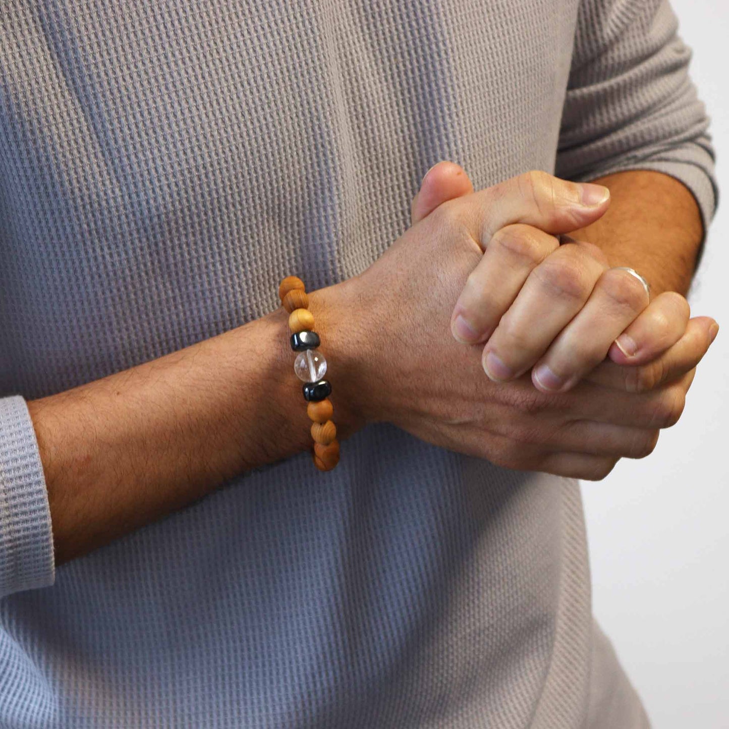 Unisex Cedarwood Crown Chakra Bracelet with Clear Quartz product packaging on clean background from Quintessential Holistic Health Ltd