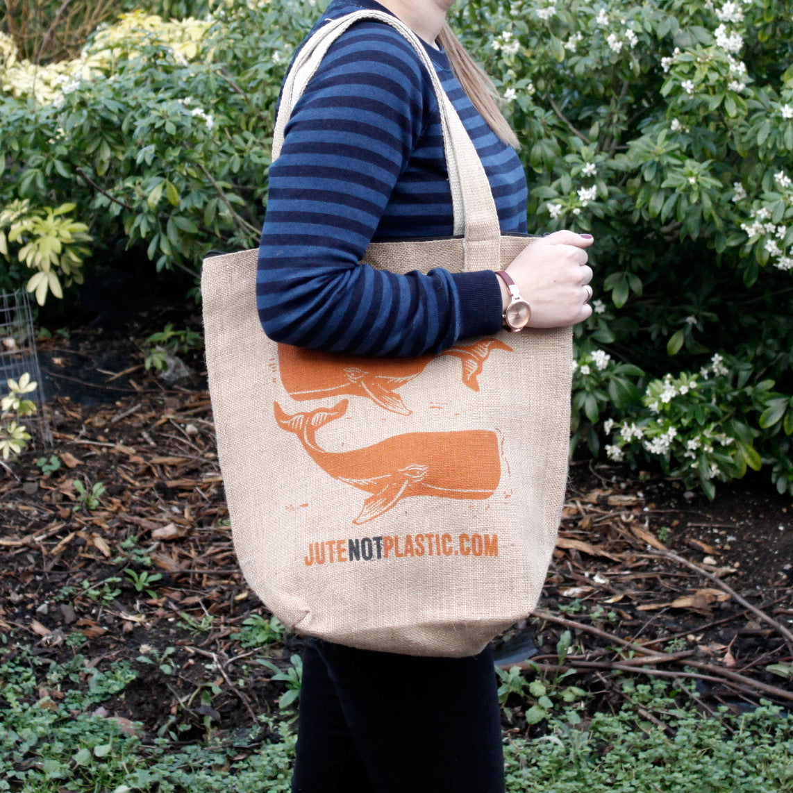 Eco-Friendly Jute Bag - Two Whales - Random Black or Yellow, worn over one shoulder with orange whale artwork visible by Quintessential Holistic Health Ltd