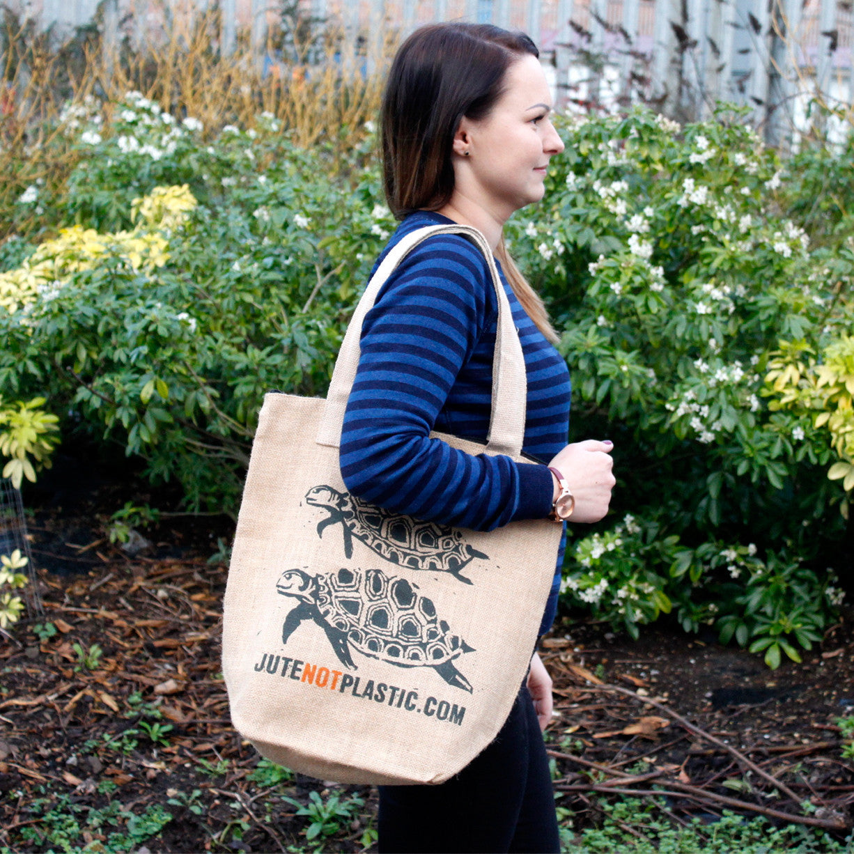 Eco-Friendly Jute Bag - Two Turtles - Random Black or Yellow, worn over one shoulder with two dark turtle prints visible by Quintessential Holistic Health Ltd