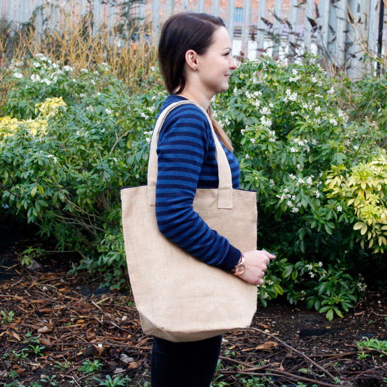 Natural Jute Open Tote Bag - 40 × 15 × 40 cm, beige tote carried over a person's shoulder outdoors, by Quintessential Holistic Health Ltd