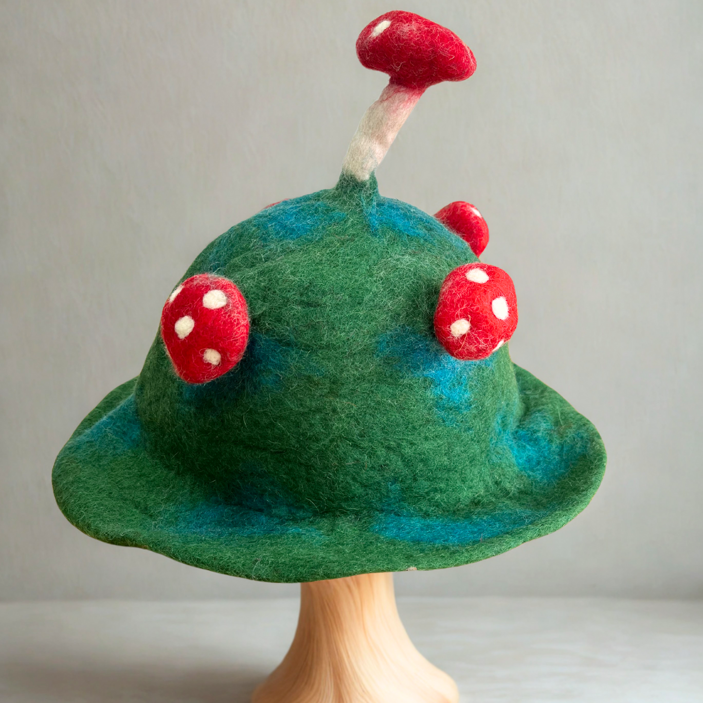 Wool Felted Handmade Mushroom Hat - Mountain Green product packaging on clean background from Quintessential Holistic Health Ltd