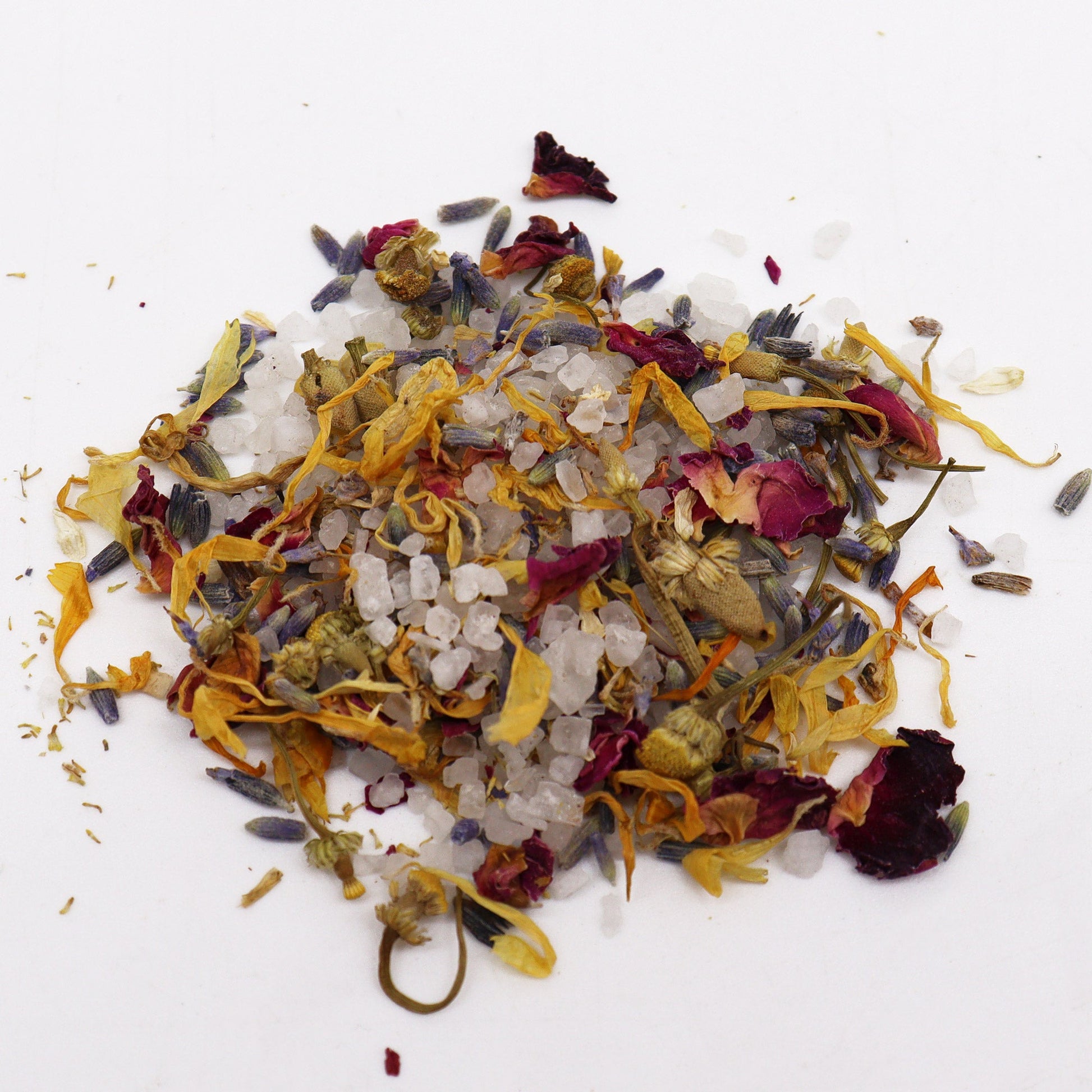 Natural Floral Bath Soak - 140g, mound of pale crystals mixed with yellow, orange, purple and red petals, by Quintessential Holistic Health Ltd
