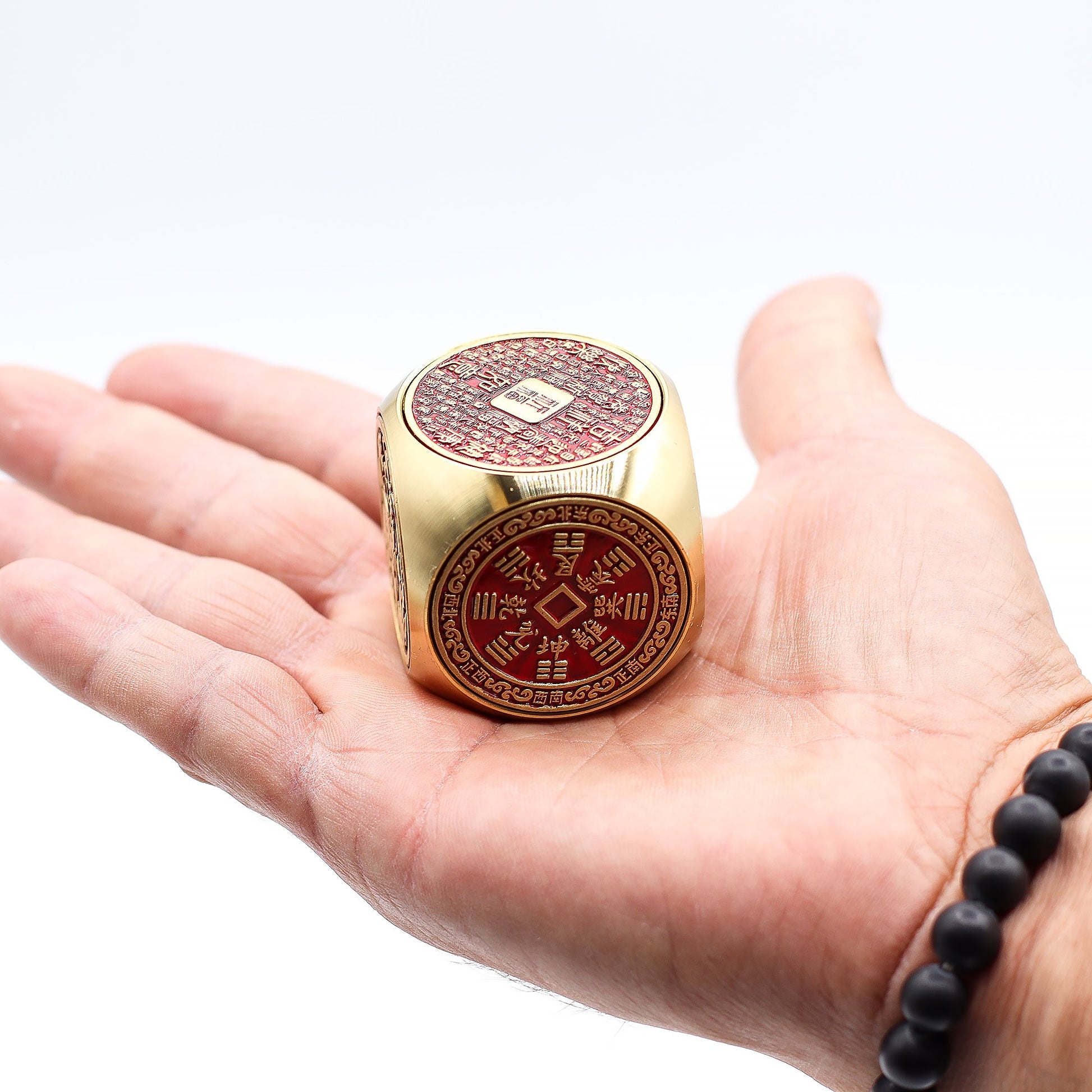 Feng Shui Fortune Spinner - Flat / Red and Brass Prosperity Cube product packaging on clean background from Quintessential Holistic Health Ltd