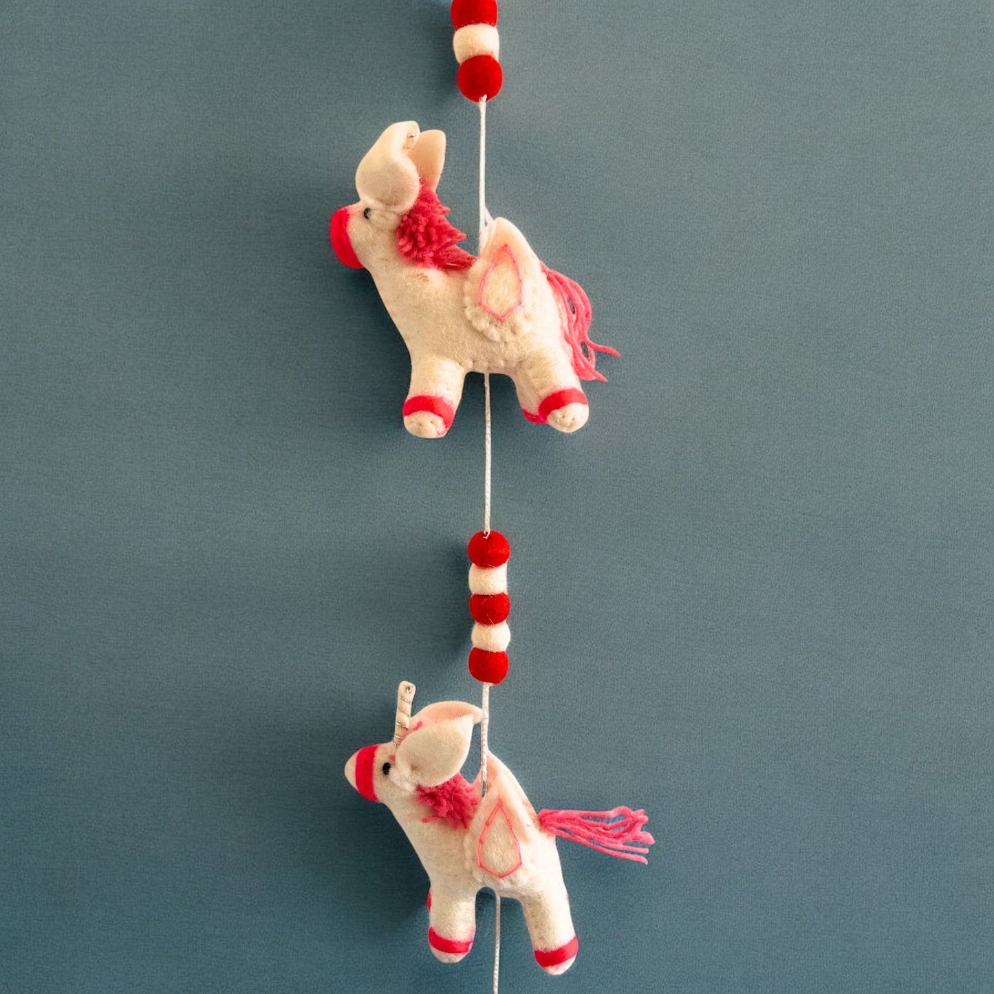 Handmade Childs Nursery Felt Wall or Ceiling Hanging - Unicorns product packaging on clean background from Quintessential Holistic Health Ltd