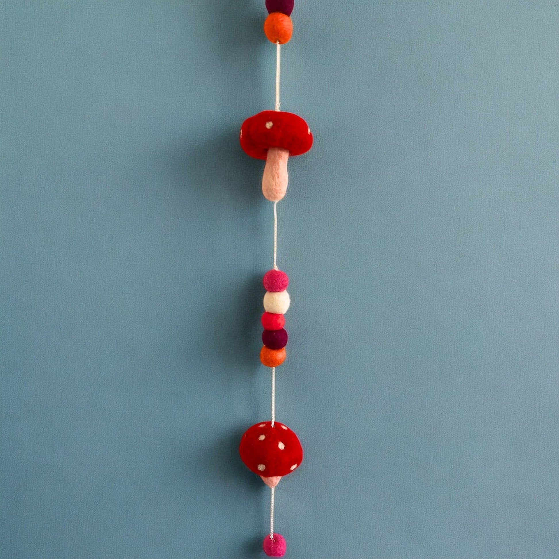 Handmade Childs Nursery Felt Wall or Ceiling Hanging - Red Mushrooms product packaging on clean background from Quintessential Holistic Health Ltd