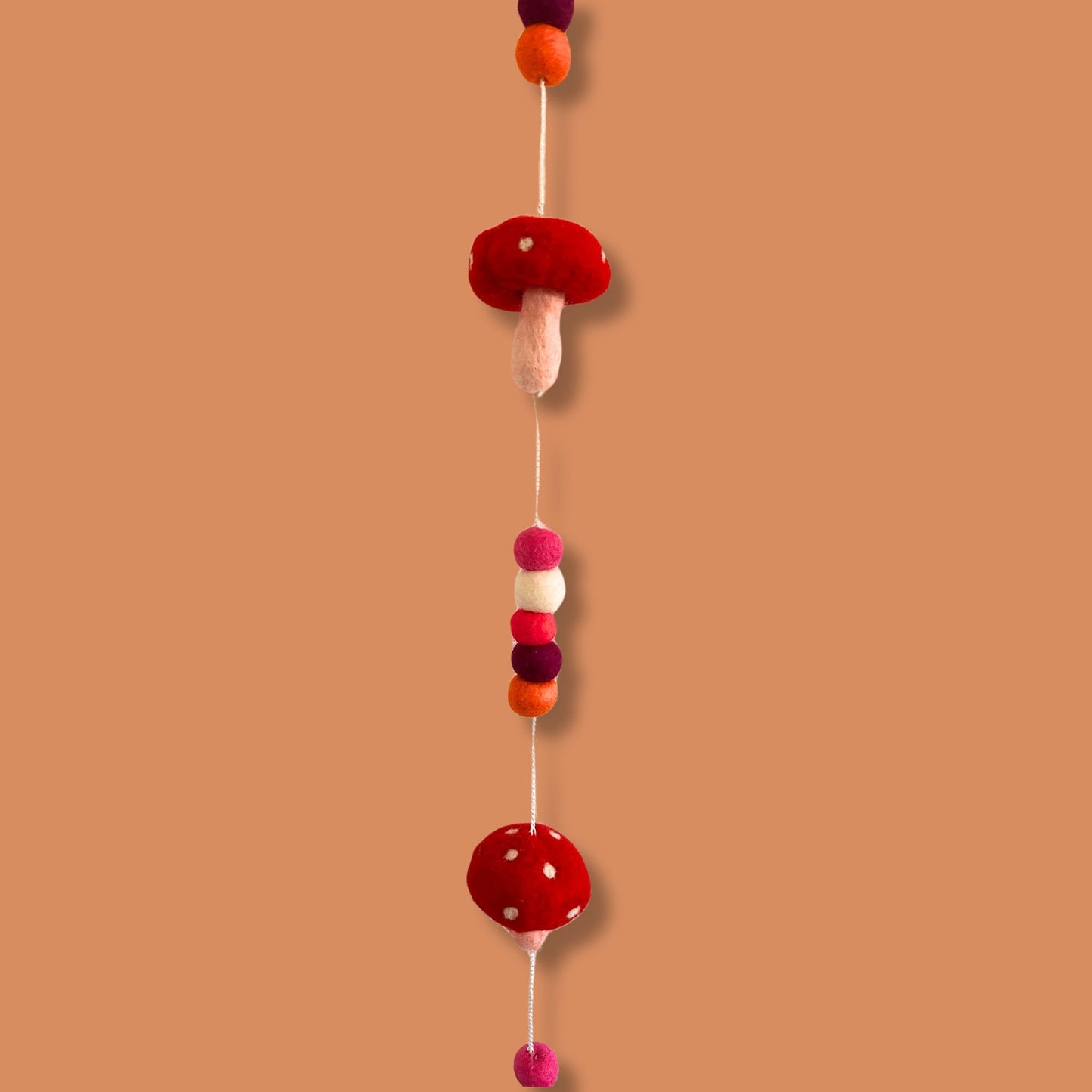Handmade Childs Nursery Felt Wall or Ceiling Hanging - Red Mushrooms product packaging on clean background from Quintessential Holistic Health Ltd