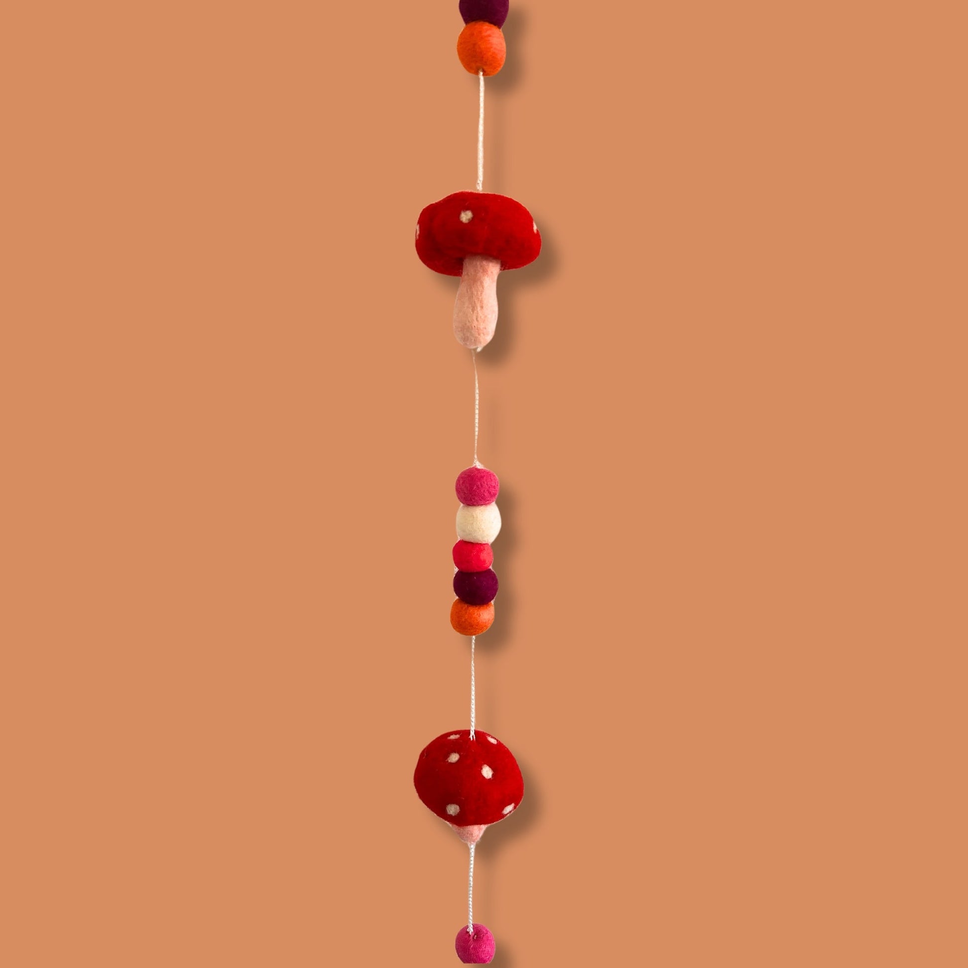 Handmade Childs Nursery Felt Wall or Ceiling Hanging - Red Mushrooms product packaging on clean background from Quintessential Holistic Health Ltd