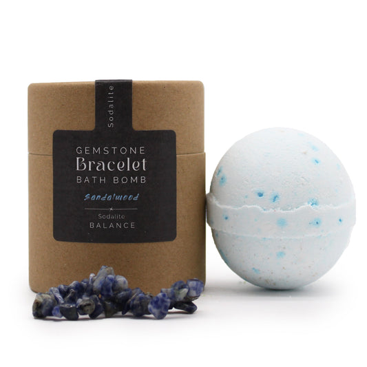 Sandalwood Sodalite Gemstone Bracelet, showing a pale blue-speckled sphere, blue stone bracelet and labelled box from Quintessential Holistic Health.