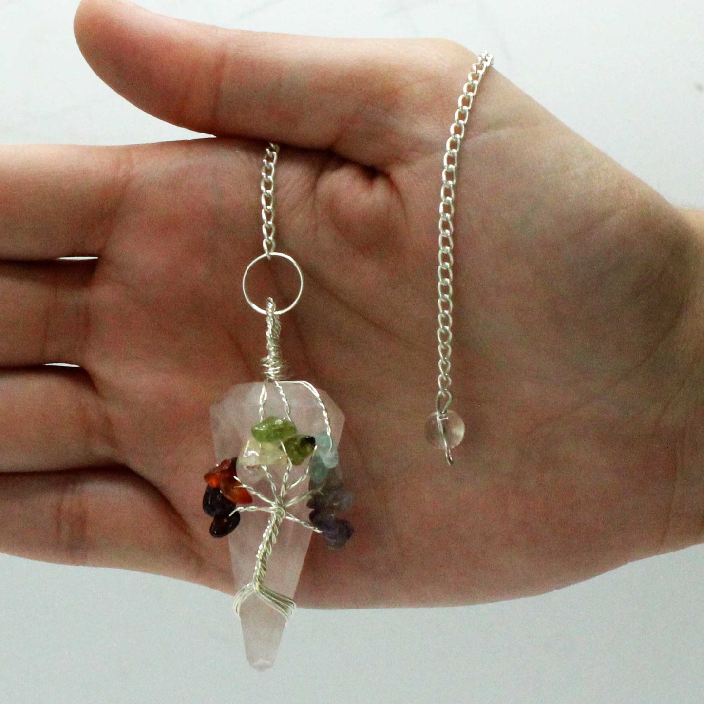 1 x Handmade Magic Radiesthesia Pendulum - Seven Chakra - Rose Quartz Gemstone product packaging on clean background from Quintessential Holistic Health Ltd