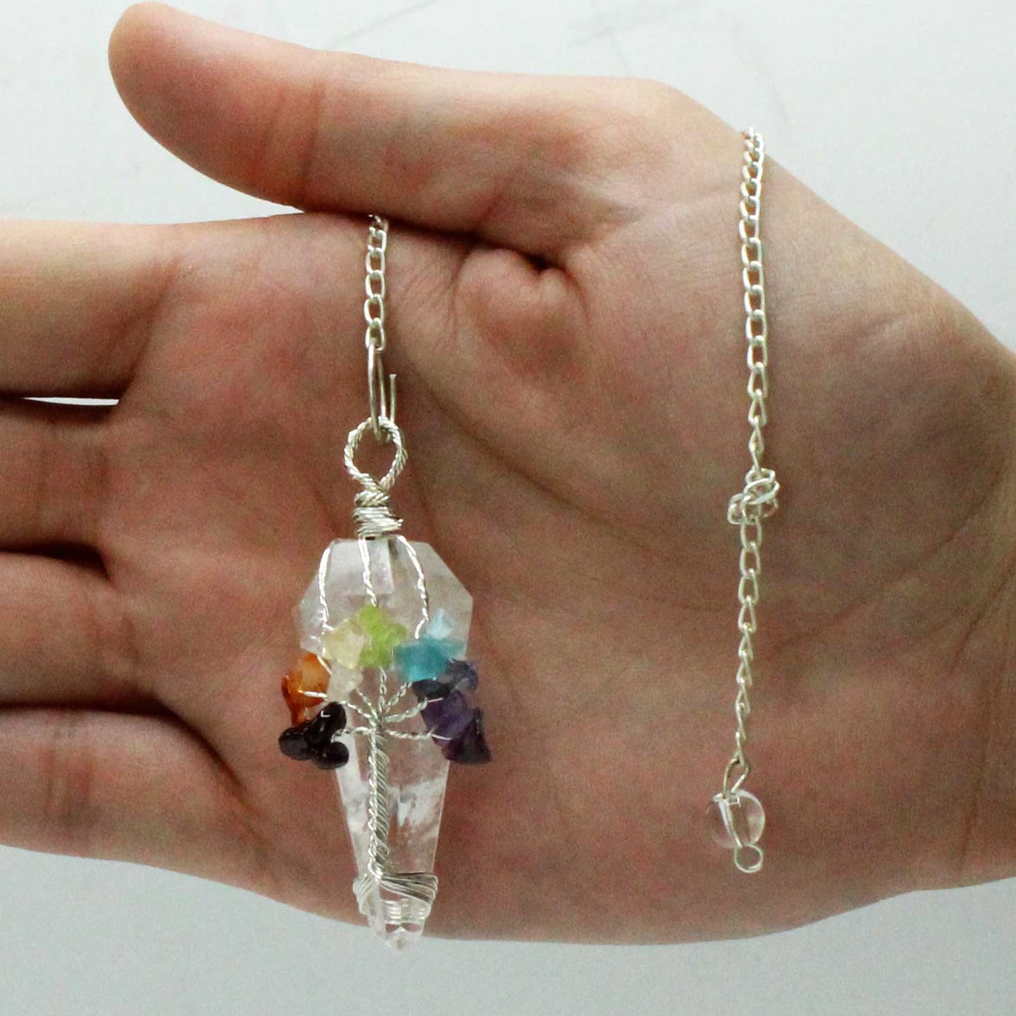 1 x Handmade Magic Radiesthesia Pendulum - Seven Chakra / Rock Quartz Gemstone product packaging on clean background from Quintessential Holistic Health Ltd