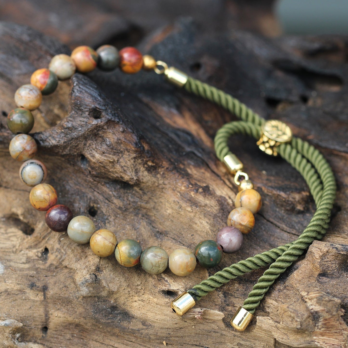 Unisex Handcrafted 18K Gold Plated Gemstone Bracelet - Moss Green String / Picasso Jasper product packaging on clean background from Quintessential Holistic Health Ltd