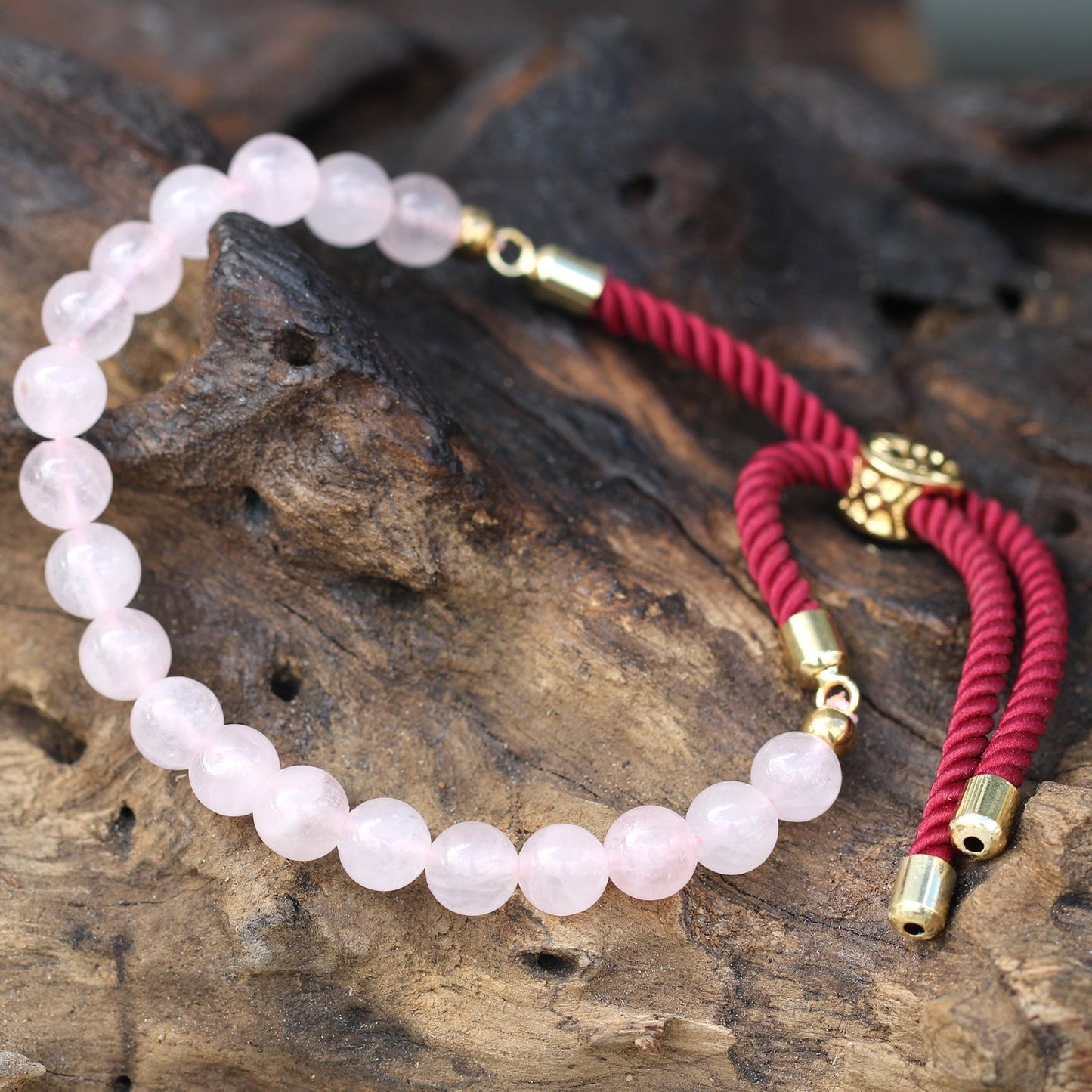 Unisex Handcrafted 18K Gold Plated Gemstone Bracelet - Burgundy String / Rose Quartz product packaging on clean background from Quintessential Holistic Health Ltd