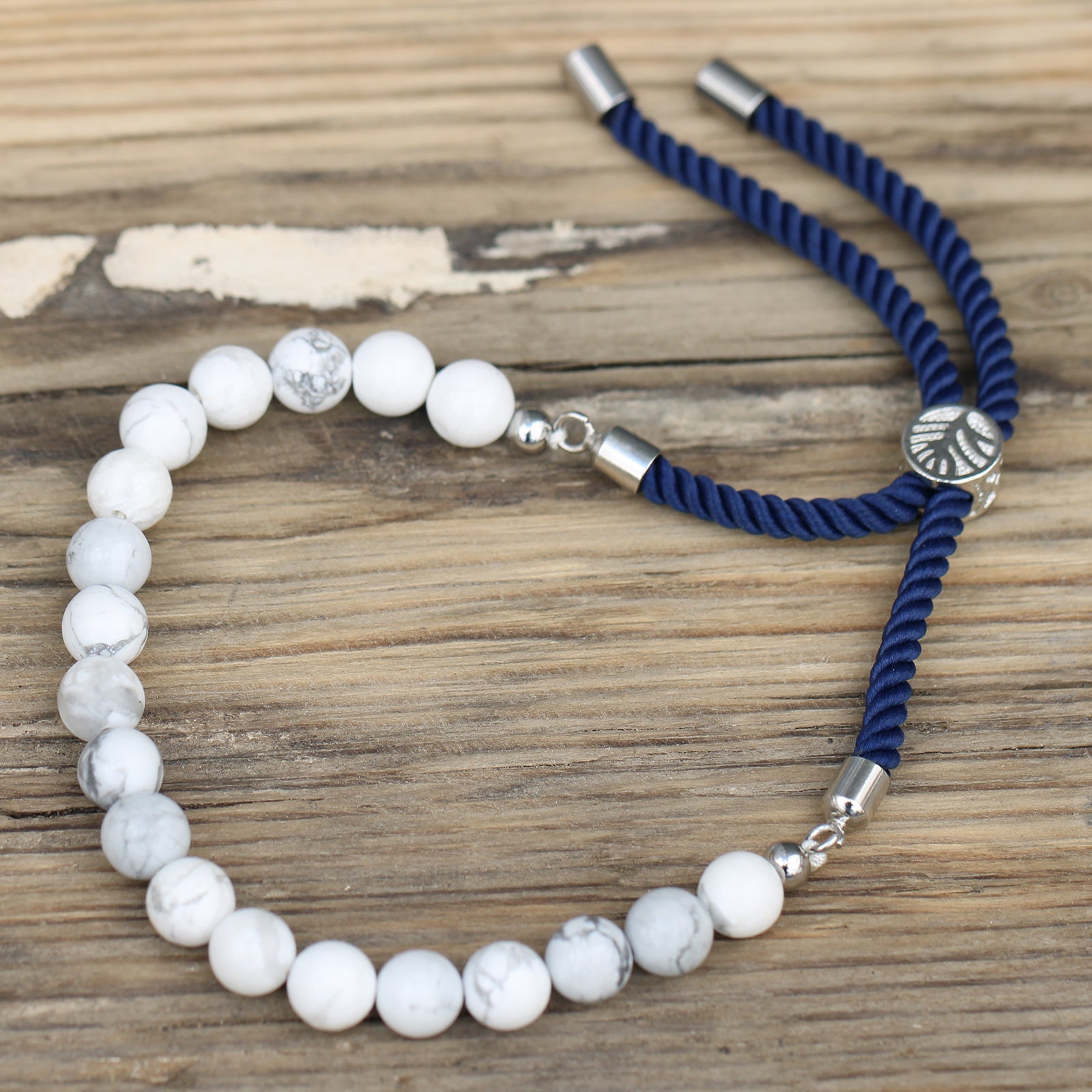 Unisex Handcrafted 925 Silver Plated Gemstone Bracelet - Navy Blue String / White Howlite product packaging on clean background from Quintessential Holistic Health Ltd