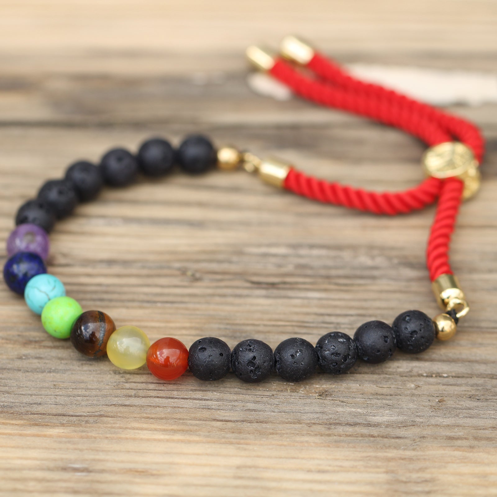 Unisex Handcrafted 18K Gold Plated Gemstone Bracelet - Red String / Lava Stone Chakra product packaging on clean background from Quintessential Holistic Health Ltd