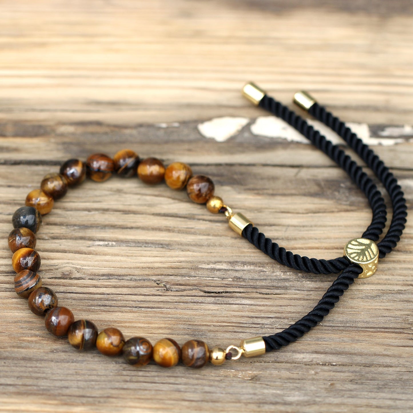 Unisex Handcrafted 18K Gold Plated Gemstone Bracelet - Black String / Tigers Eye product packaging on clean background from Quintessential Holistic Health Ltd