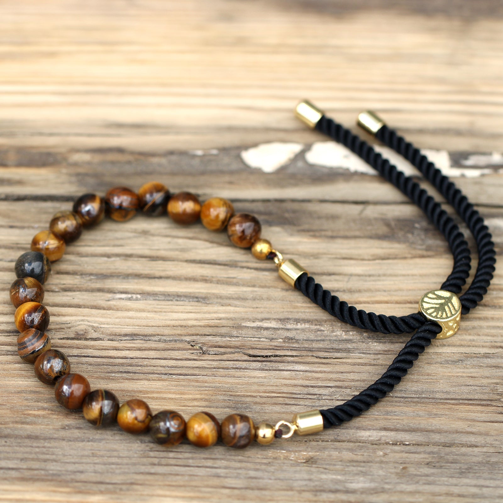 Unisex Handcrafted 18K Gold Plated Gemstone Bracelet - Black String / Tigers Eye product packaging on clean background from Quintessential Holistic Health Ltd