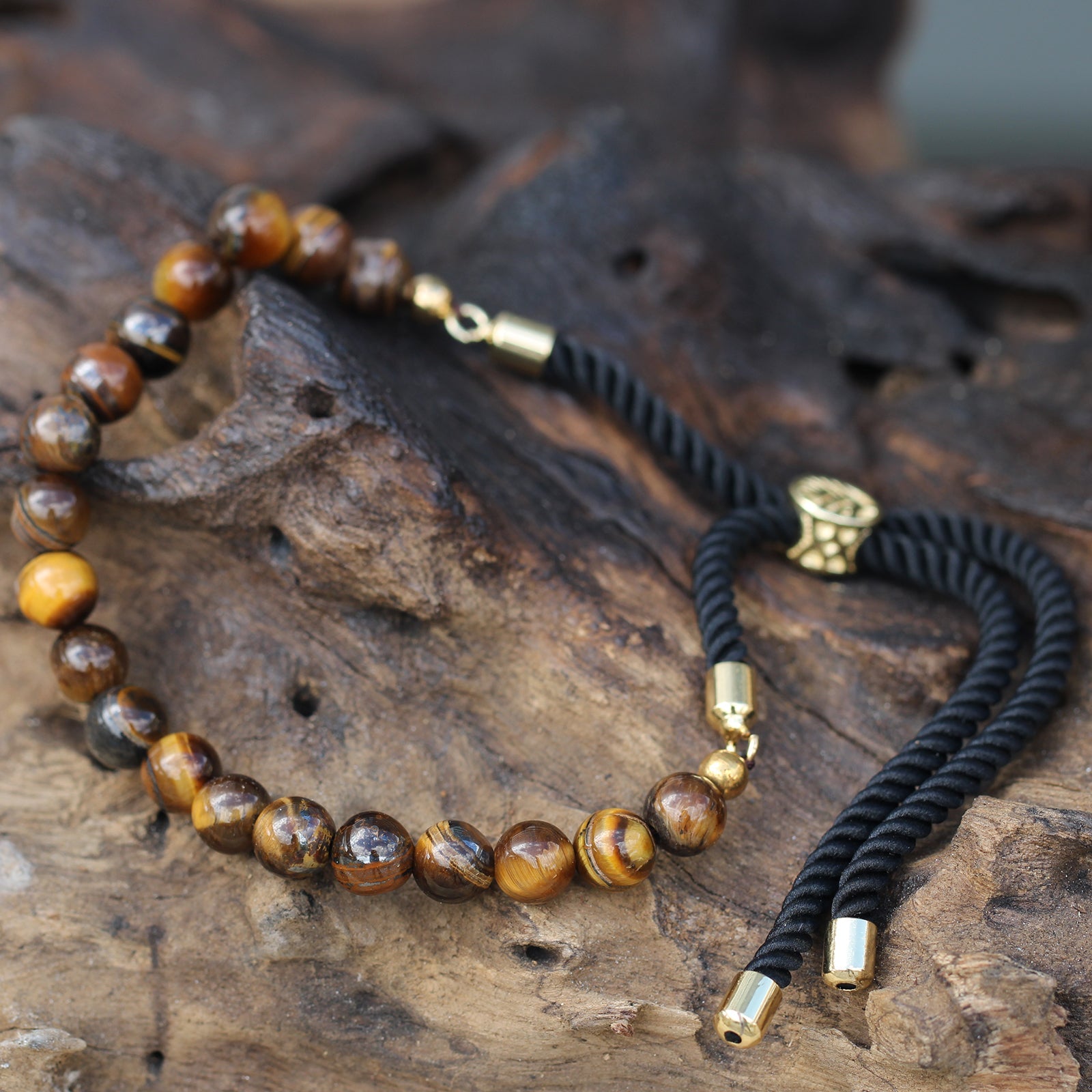 Unisex Handcrafted 18K Gold Plated Gemstone Bracelet - Black String / Tigers Eye product packaging on clean background from Quintessential Holistic Health Ltd