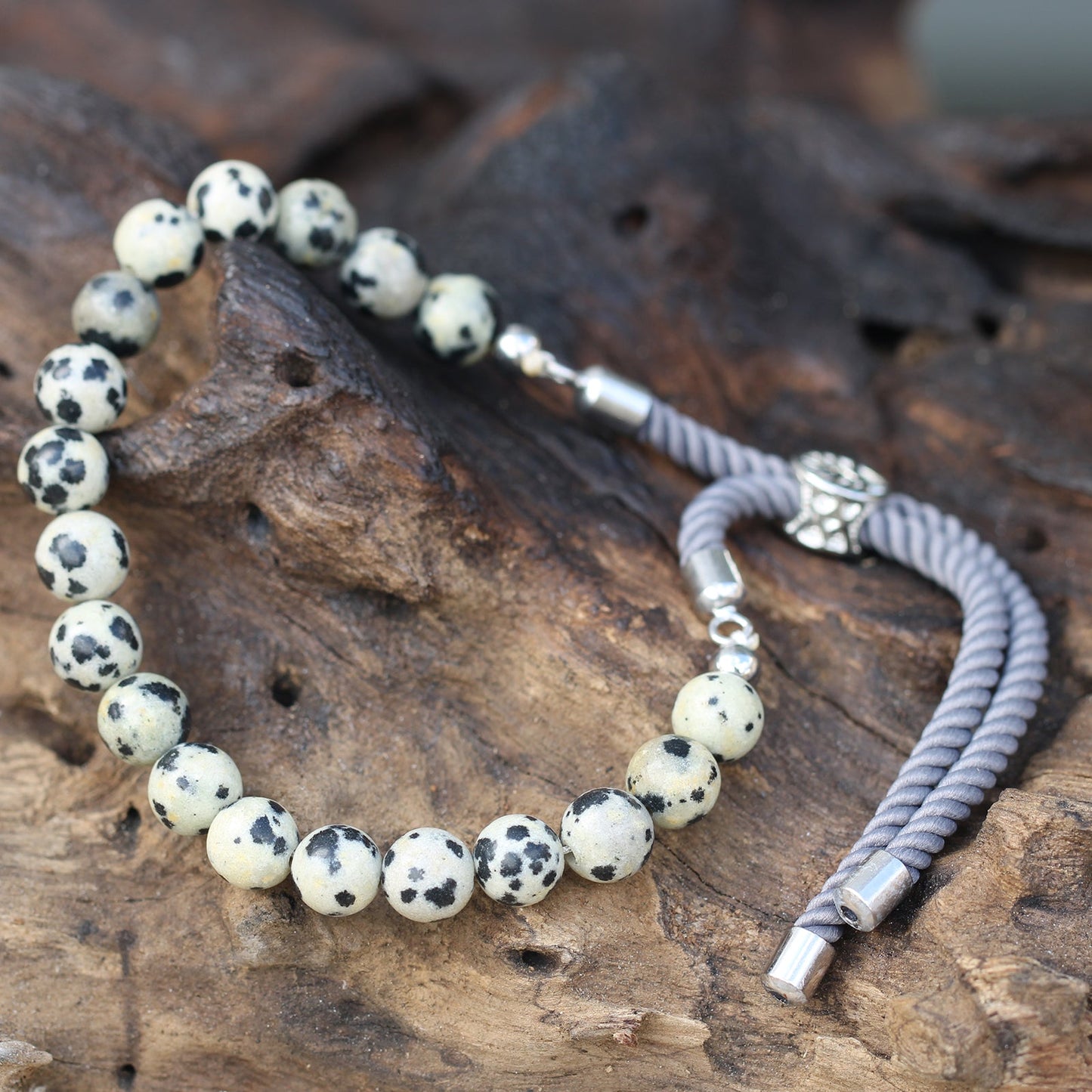Unisex Handcrafted 925 Silver Plated Gemstone Bracelet - Charcoal String / Dalmatian Jasper product packaging on clean background from Quintessential Holistic Health Ltd