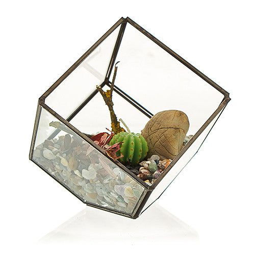Glass and Brass Corner Cube Terrarium, tilted geometric form filled with pale stones, plants and decorative pieces, by Quintessential Holistic Health Ltd