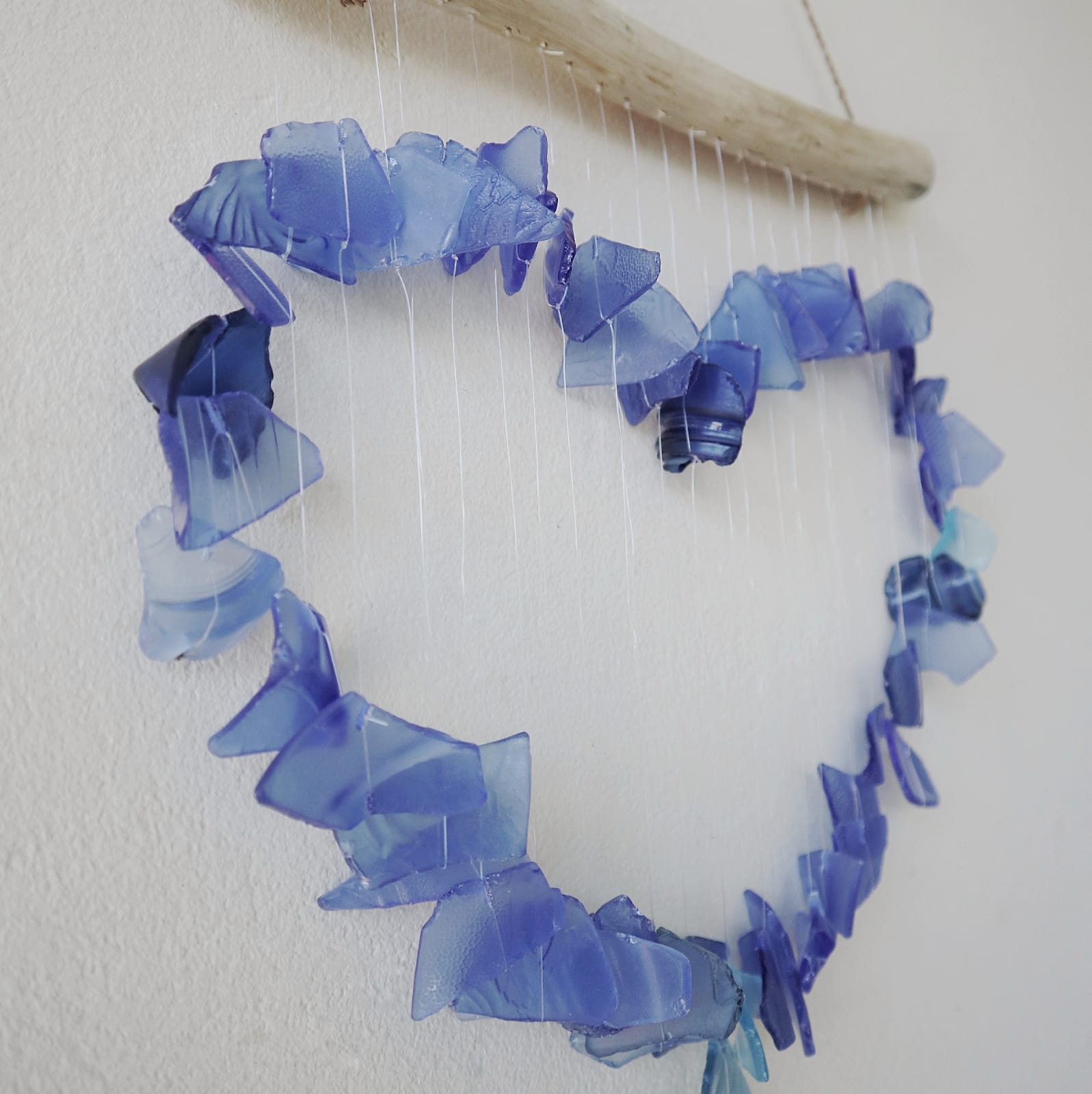 Handmade Driftwood and Recycled Glass Wind Chime - Loving Heart / Blue product packaging on clean background from Quintessential Holistic Health Ltd
