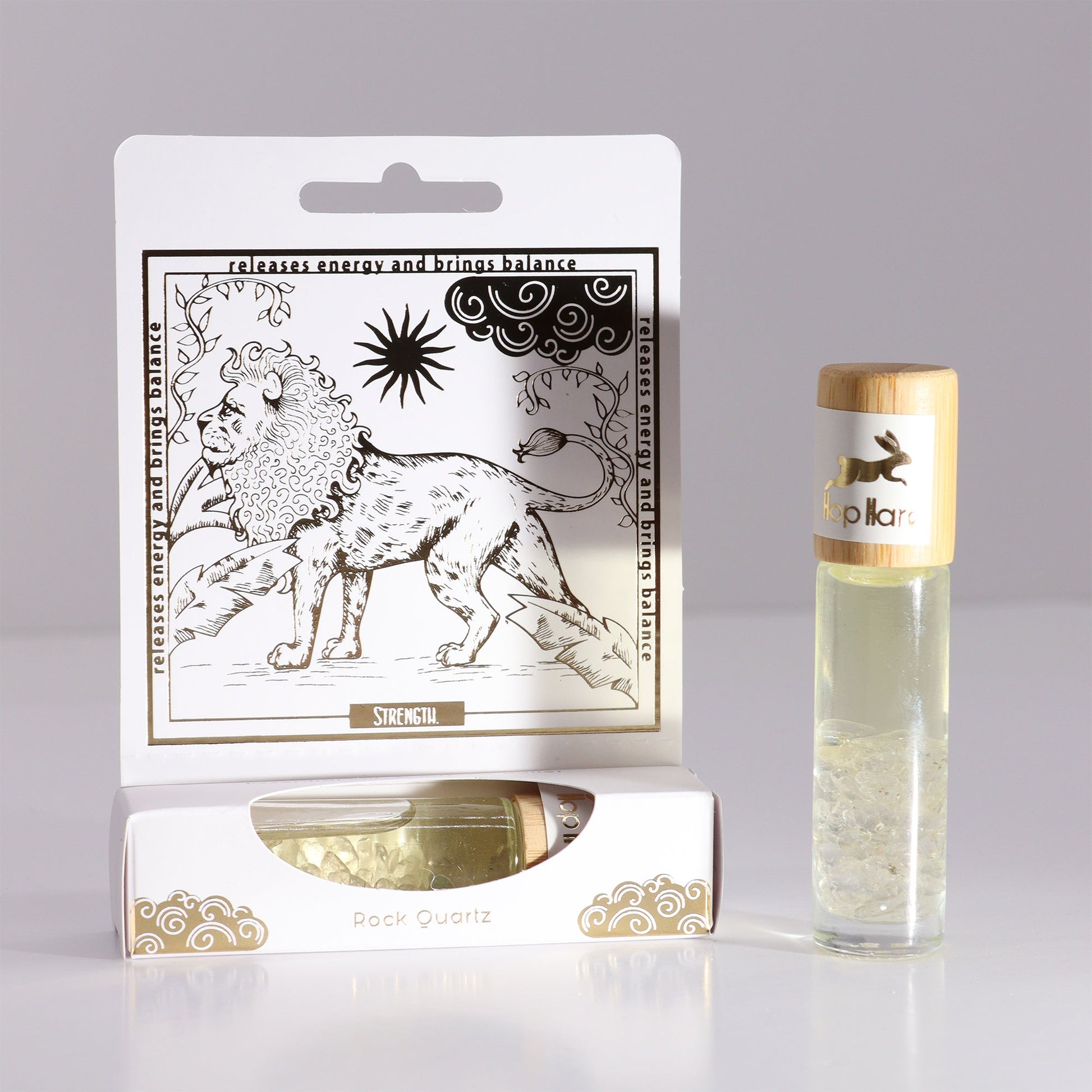 Gemstone Tarot Essential Oil Roll-On - Rock Quartz - The Lion with lion artwork and a clear bottle beside the open box by Quintessential Holistic Health Ltd