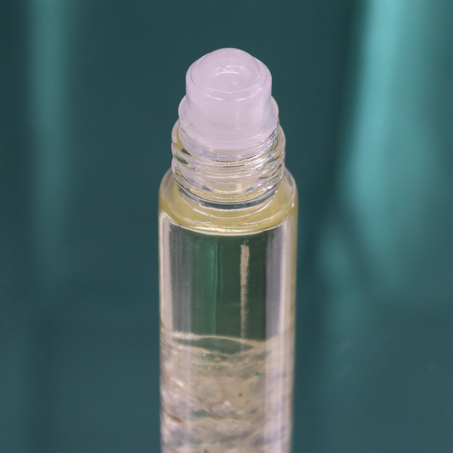 Gemstone Tarot Essential Oil Roll-On - Rock Quartz - The Lion showing a pale roller top above clear chips by Quintessential Holistic Health Ltd