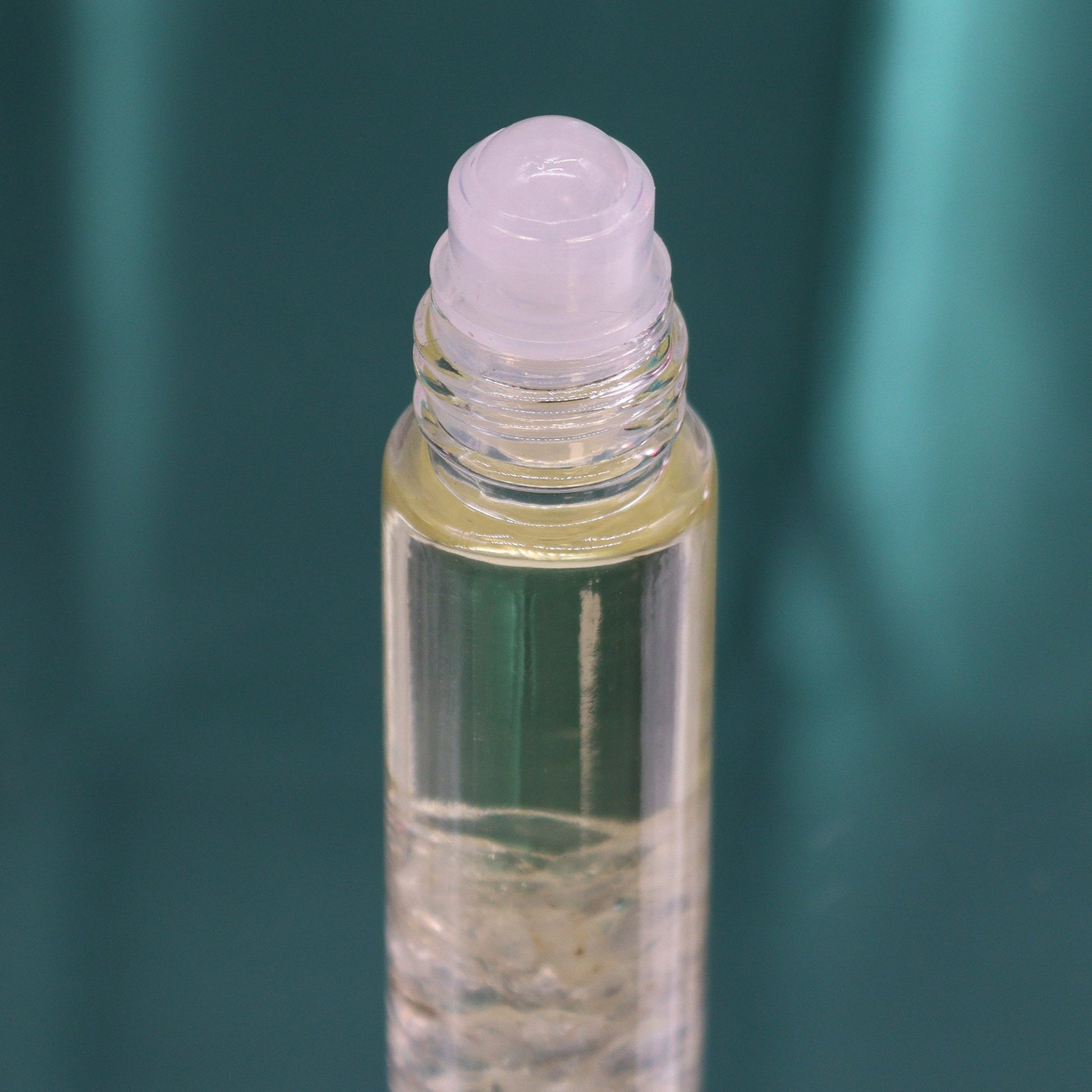 Gemstone Tarot Essential Oil Roll-On - Rock Quartz - The Lion showing a pale roller top above clear chips by Quintessential Holistic Health Ltd