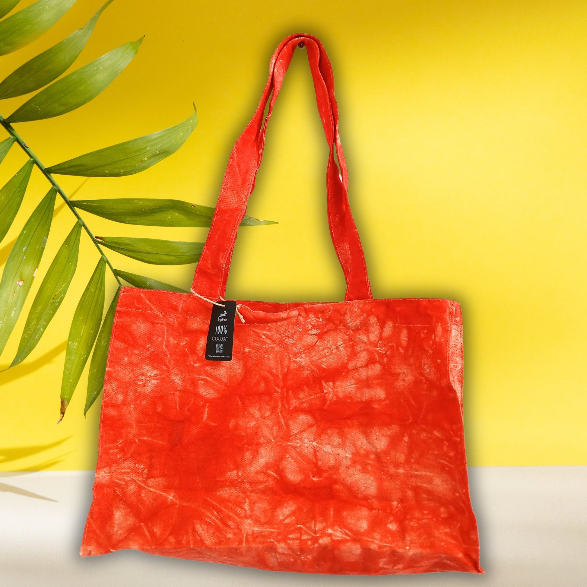 Handmade 100% Natural Cotton Handy Bag - Desert Orange Stonewash with bright orange-red marbling and a small black tag by Quintessential Holistic Health Ltd