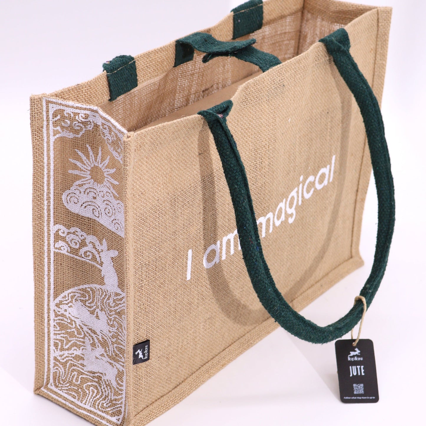 Eco-Friendly Jute Tote Bag - I Am Magical, displaying white text, decorative side artwork and a hanging tag by Quintessential Holistic Health Ltd