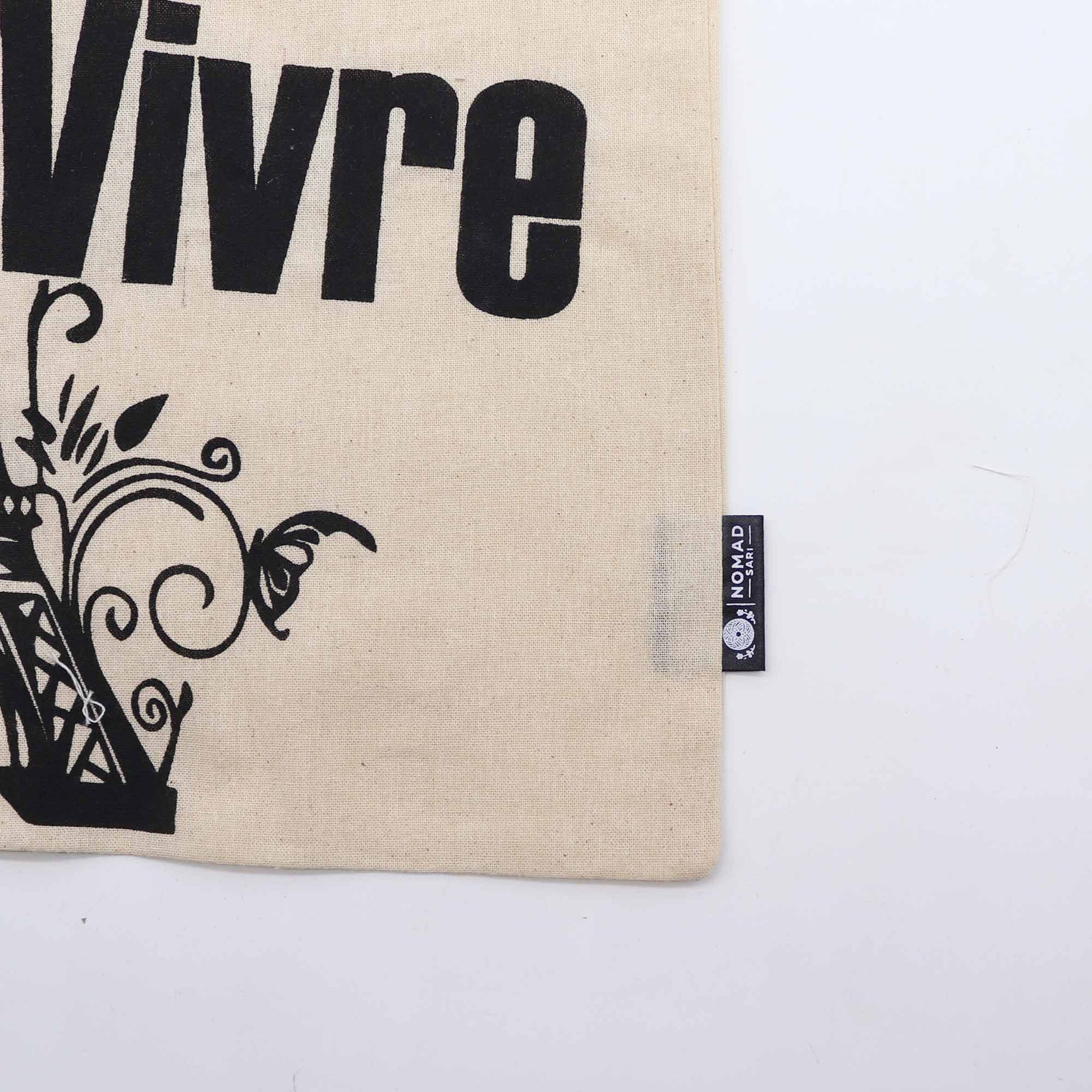 Iconic Natural Cotton Tote Bag - Joie de Vivre - Natural, close-up of Vivre lettering, floral scrollwork and side label by Quintessential Holistic Health Ltd