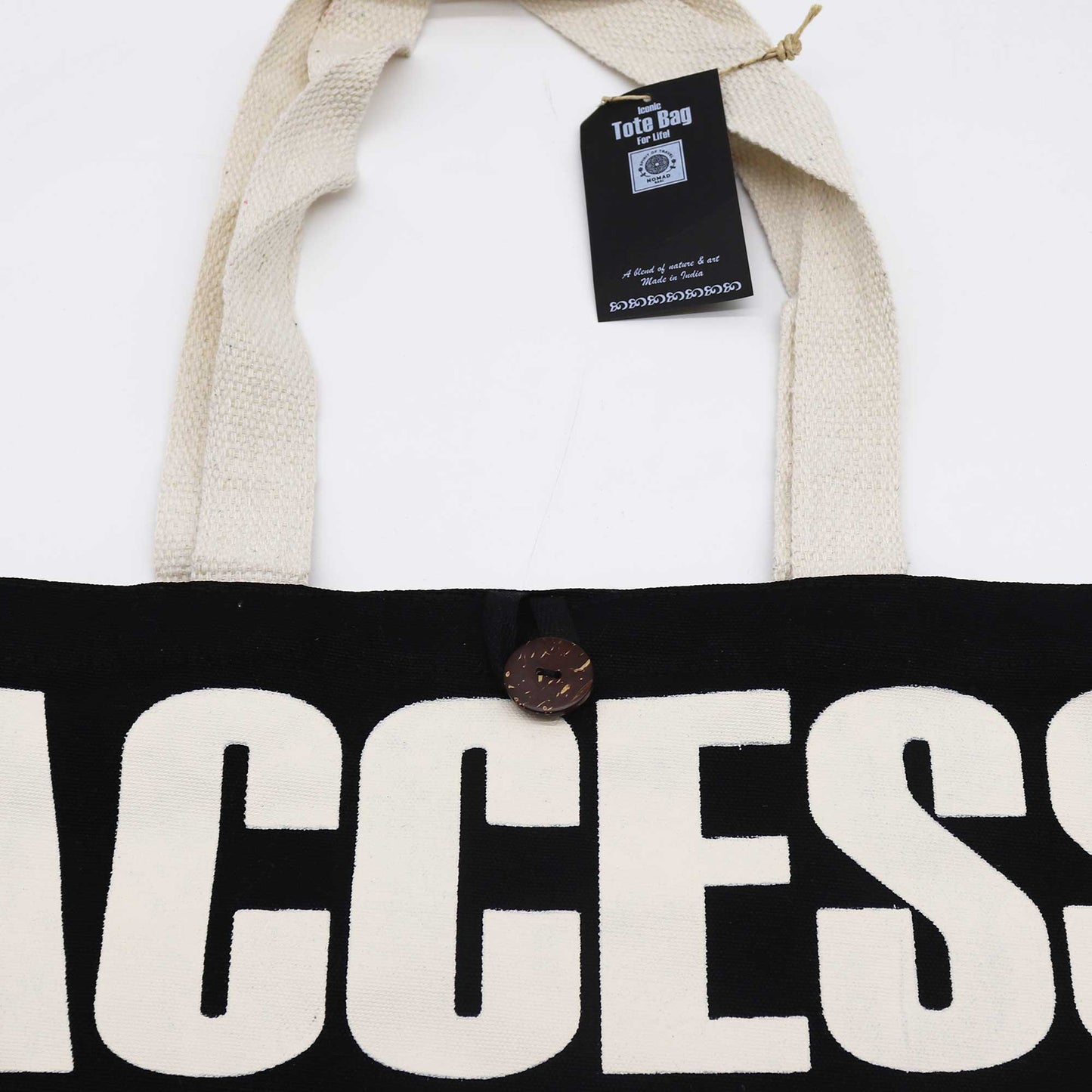 Iconic Cotton Classic Tote Bag - Access All Areas - Black & Natural, close-up of cream ACCESS lettering, brown button and hanging tag by Quintessential Holistic Health Ltd