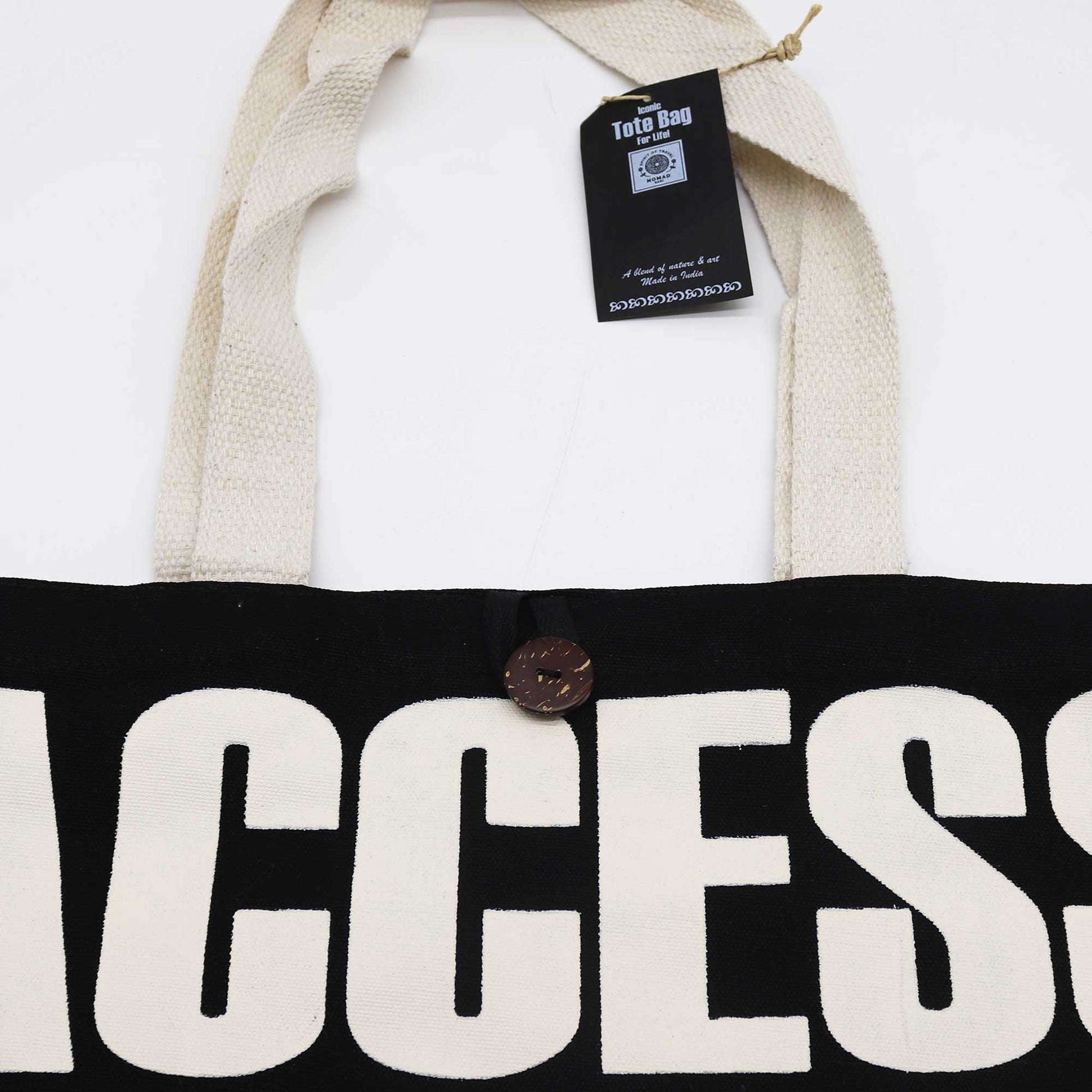Iconic Cotton Classic Tote Bag - Access All Areas - Black & Natural, close-up of cream ACCESS lettering, brown button and hanging tag by Quintessential Holistic Health Ltd