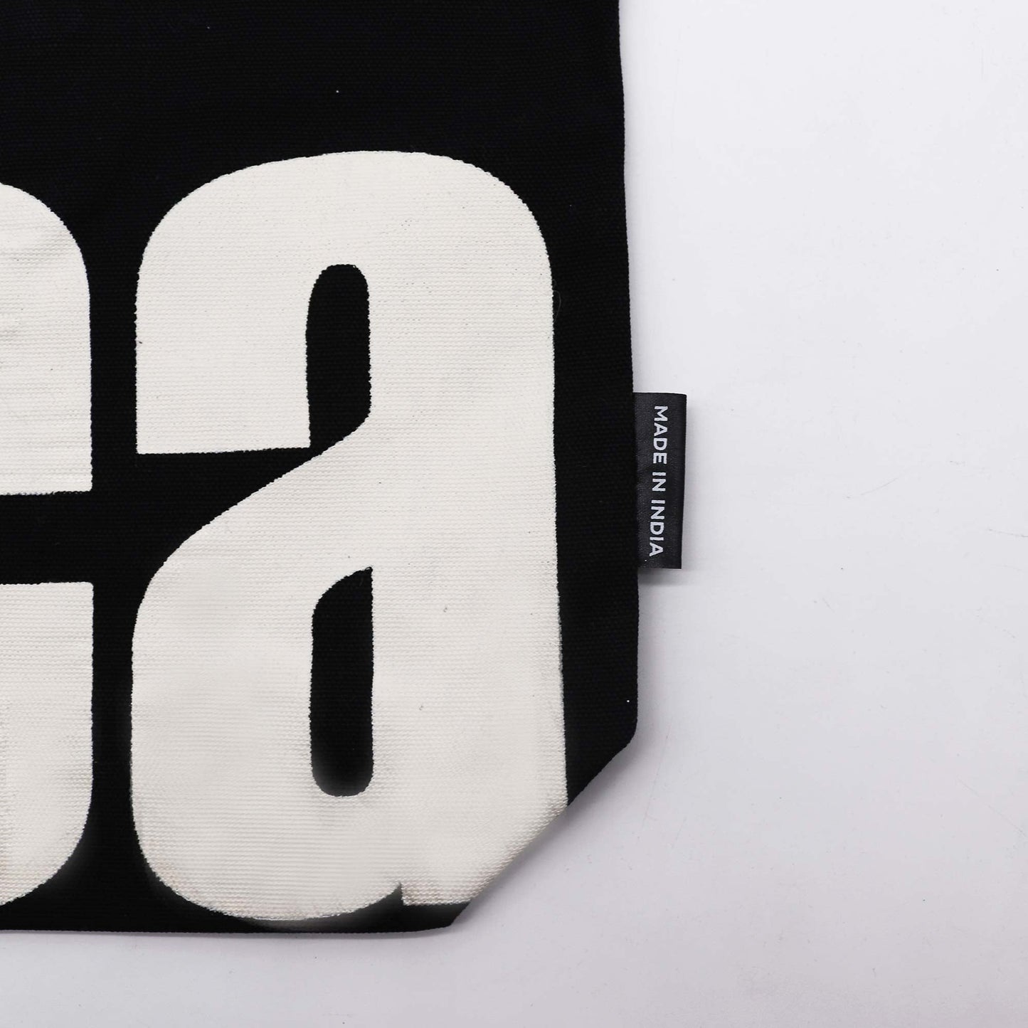 Iconic Cotton Classic Tote Bag - Mi Vida Loca - Black & Natural, close-up of lower cream lettering, corner and side label by Quintessential Holistic Health Ltd