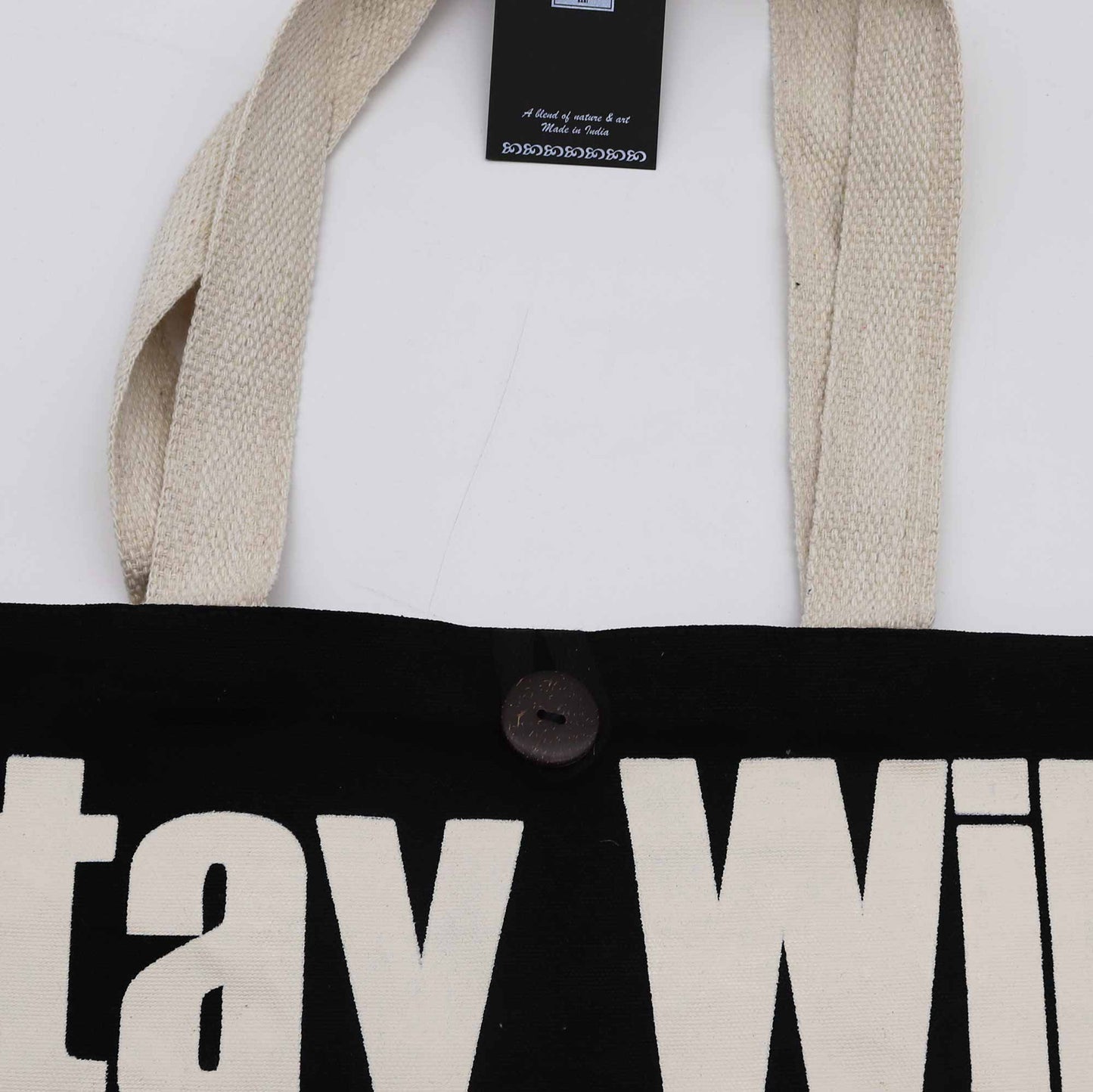 Cotton Classic Tote Bag - Stay Wild, Mood Child - Black & Natural, close-up of cream Stay Wild lettering, natural straps and brown button by Quintessential Holistic Health Ltd