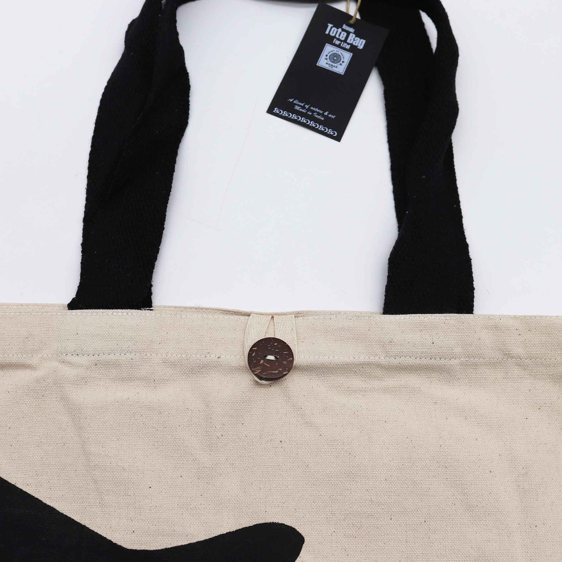 Iconic Cotton Classic Tote Bag - WTF Black Cat - Natural, close-up of black trim, brown button, hanging tag and partial cat print by Quintessential Holistic Health Ltd