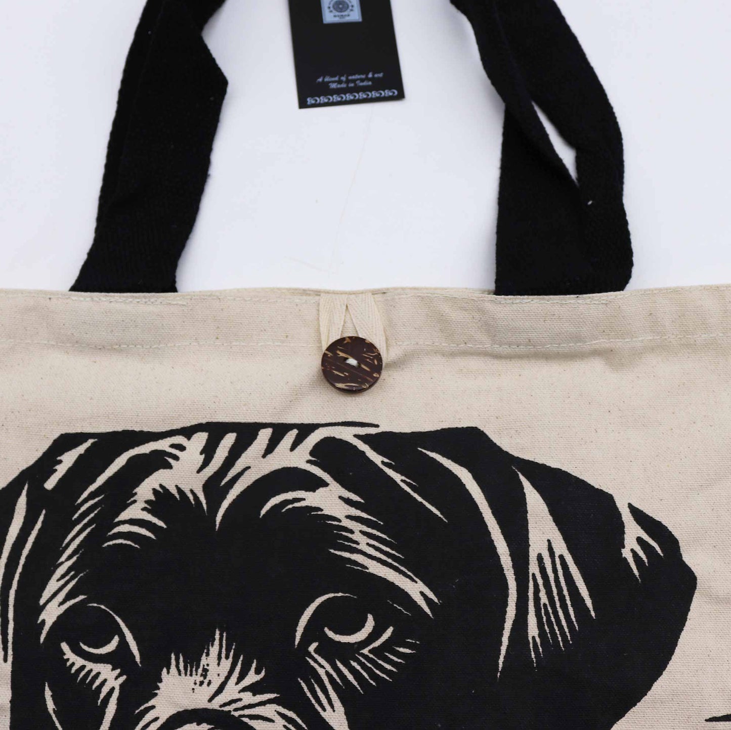 Cotton Classic Tote Bag - It's a Dog's Life - Black & Natural, close-up of the dog portrait, black trim, brown button and tag by Quintessential Holistic Health Ltd