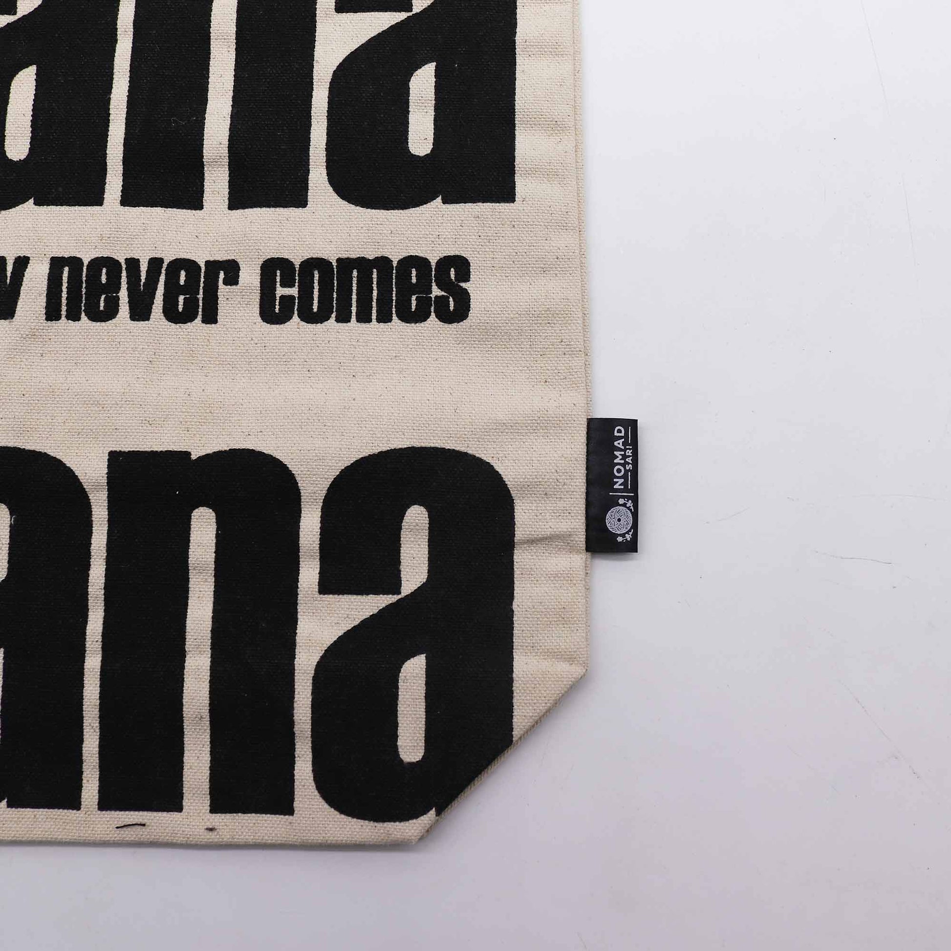 Iconic Cotton Classic Tote Bag - Mañana Mañana - Natural, close-up of lower black lettering, slogan text, corner and side label by Quintessential Holistic Health Ltd