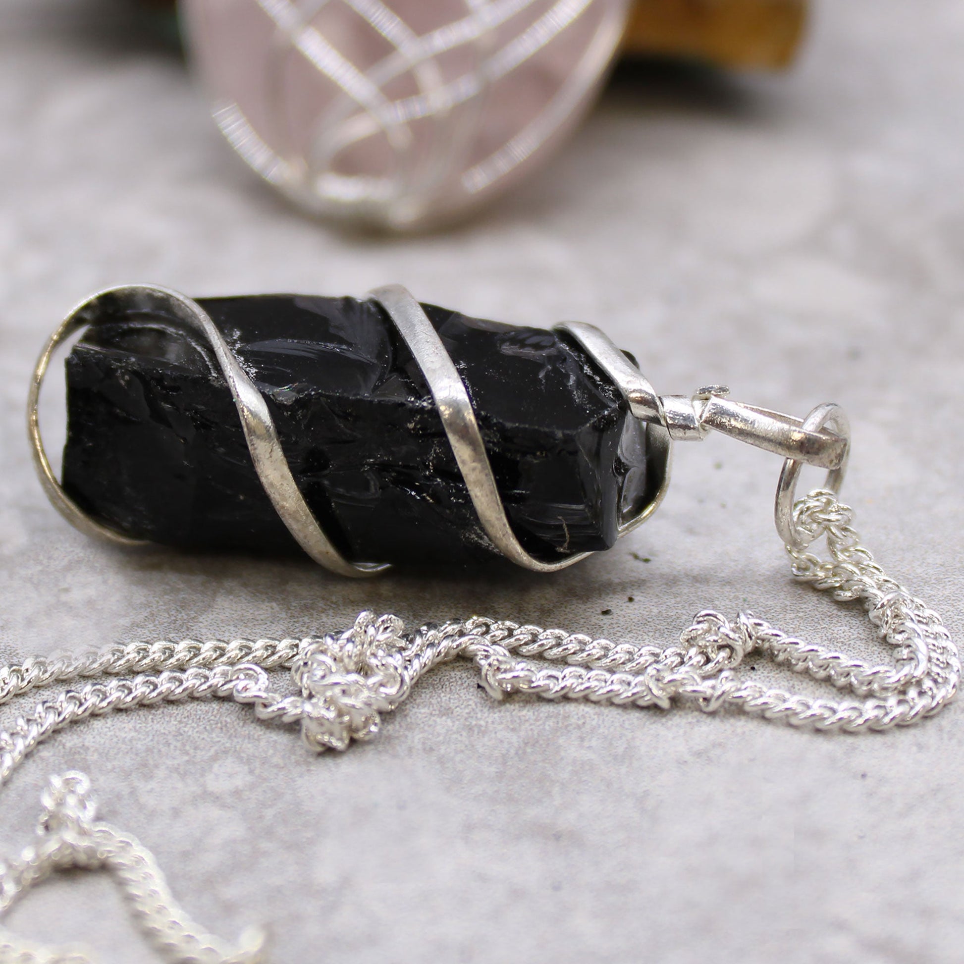 Cascade Wrapped Gemstone Necklace - Rough Black Onyx product packaging on clean background from Quintessential Holistic Health Ltd