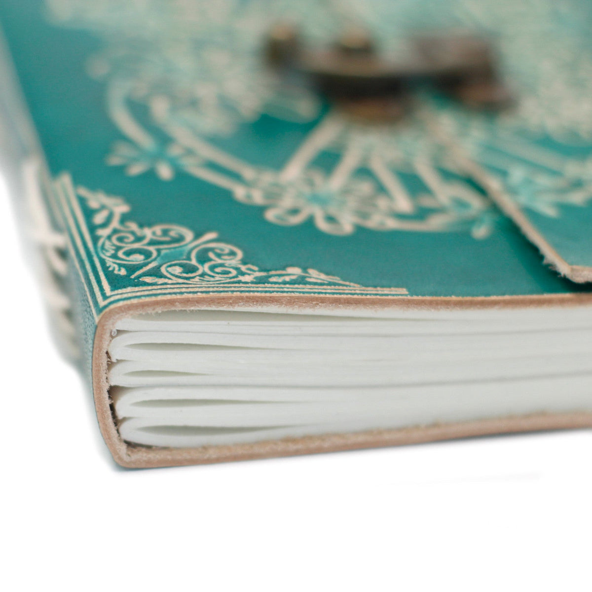 Leather-Bound Peace Notebook - Medium Green, Metal Clasp close-up showing layered cream page edges and white cover linework by Quintessential Holistic Health Ltd