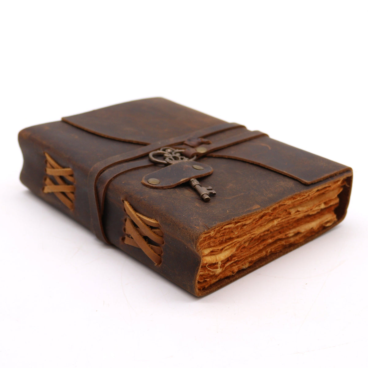 Oiled Leather 200-Page Deckle-Edged Notebook – Medium Brown lying closed with layered page edges, stitched binding and a key charm by Quintessential Holistic Health Ltd