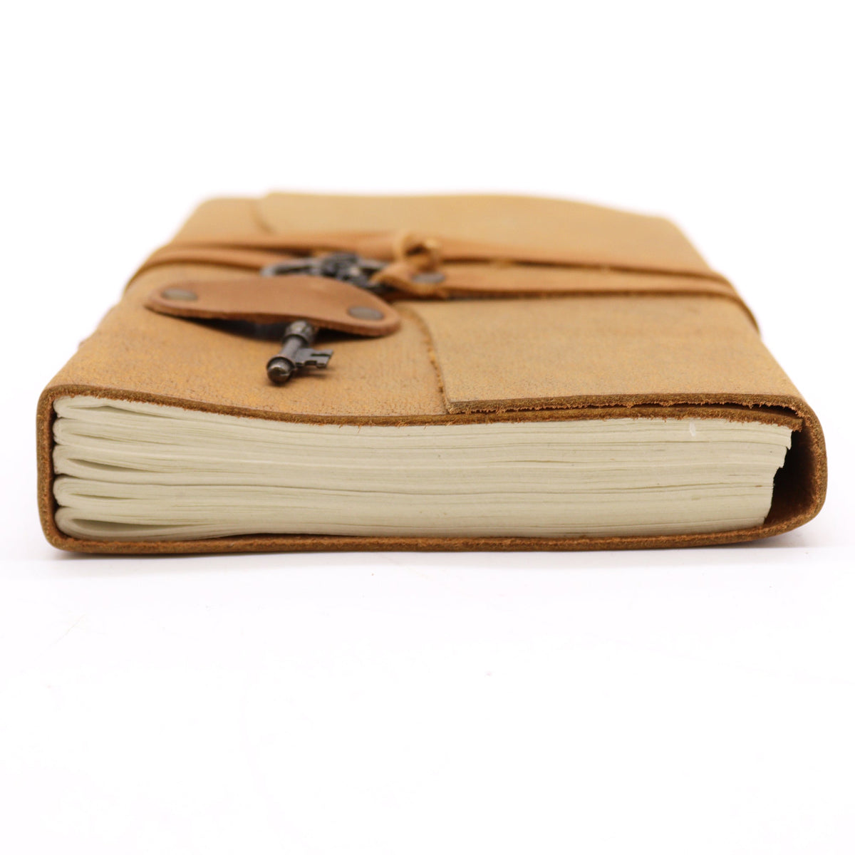 Oiled Leather 200-Page Notebook with Strap & Key – Medium Tan shown from the page edge with cream pages and a wraparound closure by Quintessential Holistic Health Ltd